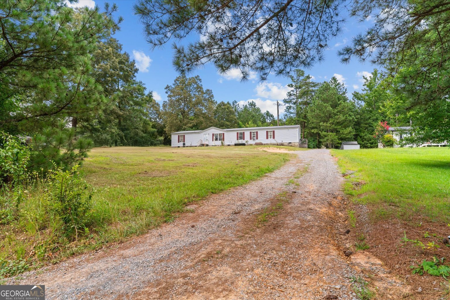 Well-maintained double-wide mobile home on a permanent foundation with 2,128 sq. ft. of living space. This 5-bedroom, 2-bath home sits on a level and cleared 0.5-acre lot, offering plenty of room for outdoor enjoyment, gardening, or small-scale farming. Only one owner since it was placed (never moved). Home features include: Metal roof (4 years old) Central A/C throughout New wood-burning fireplace 3-year-old water heater 500-gallon gas tank (included) Storage building in backyard (included) Zoned Rural Residential, allowing crop production, hobby farming, and more. Perfect for buyers seeking space, flexibility, and country living without being too far from town - located just 10 minutes from Eton and 10 minutes from Crandall for convenient access to local shops, schools, and amenities. This home is move-in ready and ideal for first-time homebuyers looking for both value and versatility.