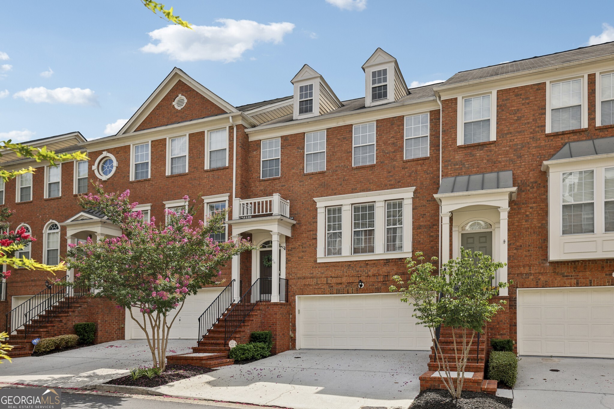 Move-In Ready Townhome in an Unbeatable Location! Nestled just minutes from The Battery, Truist Park, Vinings, Smyrna Market Village, Cumberland Mall, and the Silver Comet Trail, this spacious and light-filled townhome offers the perfect blend of comfort and convenience with easy access to I-285 and a quick 15-minute drive to Buckhead. Inside, you'll find a flowing floorplan with wide-plank flooring that seamlessly connects the fireside Family Room to the Dining Area, with access to a private Rear Deck ideal for morning coffee or evening relaxation. The spacious Kitchen is perfect for everyday living and entertaining, featuring dark wood cabinetry, stainless steel appliances, a tile backsplash, and a central island with a Breakfast Bar. Upstairs, retreat to the Primary Suite with a large Walk-In Closet and a spa-style Ensuite Bathroom complete with Dual Vanities, a Soaking Tub, and a separate Tiled Shower. A second Bedroom also offers a Walk-In Closet and access to the second Full Bathroom. The lower level includes a third Bedroom and a Half Bath perfect for a Home Office, Gym, or Media Room with access to the Private Patio and Fully Fenced Backyard. Enjoy life in a welcoming community with a Junior Olympic Pool, scenic Greenspaces, and Walking Trails. This one checks all the boxes don't miss your opportunity!