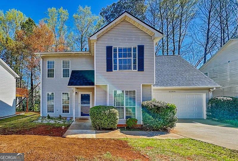Step inside this beautifully renovated 4-bedroom, 2.5-bath home with a spacious 2-car garage. Modern laminate flooring flows throughout, while the sleek kitchen showcases stainless steel appliances, an island centerpiece, and a convenient breakfast bar. Outdoors, you'll find a large wooden deck overlooking a tree-filled yard-perfect for gatherings, relaxation, and enjoying the natural surroundings.