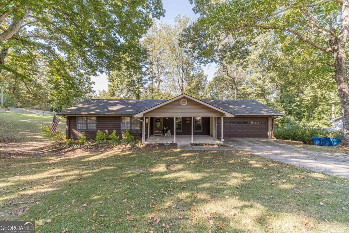 Welcome to 1222 La Mesa Drive, a charming and well-maintained home nestled in the heart of Lawrenceville, GA. This delightful property boasts three spacious bedrooms and two full bathrooms, perfect for comfortable family living. Upon entering, you are greeted by a cozy formal living room which is adjacent to the kitchen that offers stainless steel appliances, ample counter and cabinet space for all your culinary needs, providing a perfect space for gatherings and special occasions. The master bedroom serves as a private sanctuary, offering ample space for comfort and personal touches. A well-sized en-suite bathroom completes this retreat, creating a peaceful escape from the hustle and bustle of daily life. The two well-appointed bedrooms provide versatility, making them ideal for family, guests, or office space.The partially finished basement provides a large flex space that can be easily transformed to fit your needs. Ideal for a home office, fitness area, or entertainment room, hobby/craft room, workshop or extra storage this space adds valuable square footage and extra living options to the home.    The exterior of the home offers a peaceful escape with a well-kept front yard and a private backyard oasis. The spacious patio area is perfect for outdoor gatherings, barbecues, or simply enjoying a quiet evening under the stars. Located in a quiet and established neighborhood, this home offers convenient access to local schools, parks, and shopping. Bathrooms completely renovated 2020 ,Bamboo flooring throughout main level with exception to the kitchen 5 yrs old, Main level repainted 2yrs old, Roof 6 yrs old, Hot Water Heater 3 yrs old, 2021 bosch dishwasher and  2020 GE Gas range. DonCOt miss your opportunity to make this house your home!