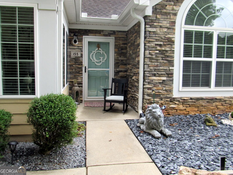 Welcome home to your move in ready 2 bed, 2 bath, flex room, single story condo. This home features an open floor plan with a large sunroom overlooking wooded greenspace. The 2,183 Sq. Ft. Canterbury Unit was recently modernized and upgraded with quartz countertops, Whirlpool kitchen appliances, a GE top loading washer and dryer, a stand alone cabinet with a stainless steel sink in the laundry room, new LED lighting fixtures and all new Moen faucets, various designer cabinet knobs and Mediterranean bronze door hardware. The vaulted great room with a gas fireplace has a trendy new lighting fixture and chandelier. The dining area opens to a spacious kitchen with a large pantry and extra clothes closet if you choose to use the bonus flex room as a bedroom rather than an office or exercise room. The hallway into the laundry room has a built-in desk and storage for office use. Engineered hardwood flooring and tile throughout make cleaning a breeze. The spacious two car garage with a new smart MyQ opener and insulated door has room for a workbench and storage cabinets. There is a clubhouse and a community pool, a full kitchen, a pool table and work out room. The walking path has several benches just to sit and enjoy the wildlife and surrounding beauty. Conveniently located, you're just minutes away from downtown Fayetteville, Trilith, Peachtree City, Fayette Piedmont Hospital and the many shops and restaurants. It is a short 25 minutes commute to the airport.