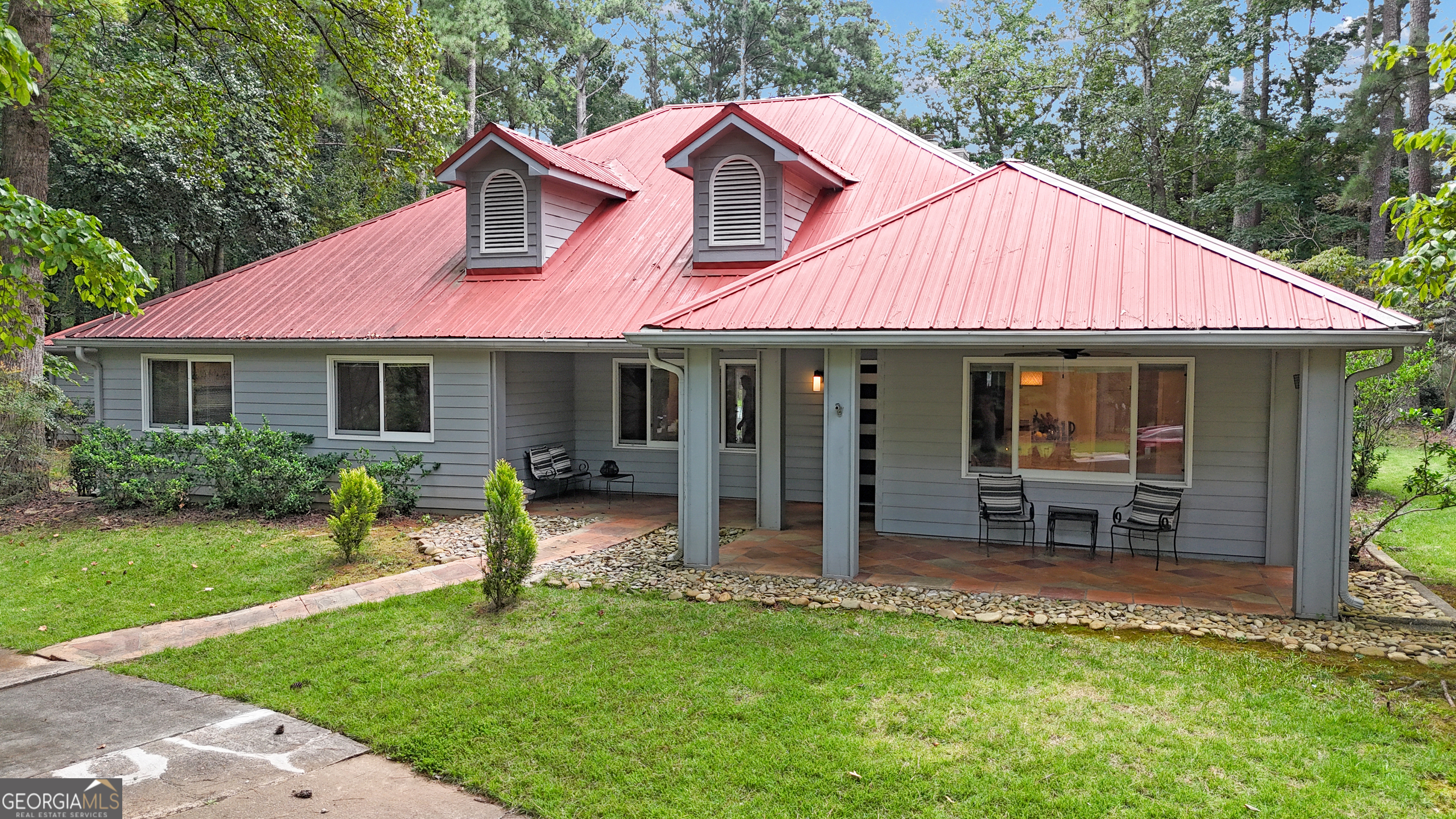 Looking for something out of the ordinary? This one story home has a cool mid-century feel and is in a sought after neighborhood where no 2 houses are alike. It is located minutes from Fayetteville and adjacent to Peachtree City. The large living room has a wet bar and will draw you in with the warm wood vaulted ceiling, hardwood floors and stone fireplace. Large windows throughout bring the outside in. The recently rejuvenated, eat in kitchen, with tile floors, newer appliances, cabinets, reverse osmosis water system, and a walk in pantry is perfect for both everyday living, and entertaining. The owner's suite is a large bedroom that will easily accommodate a king size bed, with a walk in closet. The en suite has a separate shower, tub and a double vanity. On the opposite side of the living room are the 3 secondary bedrooms and 1.5 bathrooms to share. The bedroom currently being used as a TV room, has a standup desk built into the closet. This amazing home sits on a private wooded 1 acre+ lot that you can enjoy from the front porch or entertain year round on the large covered private back patio and deck area that leads to the large saltwater pool. The detached garage with workshop is accessed via a covered breezeway. A golf cart path connects The Landings to the Peachtree City path system of nearly100 miles of multi-purpose paths. Last, but not least - this home is perfectly located - easy access to Trilith, the airports in Peachtree City & Atlanta, shopping, the new home of USA soccer and more.