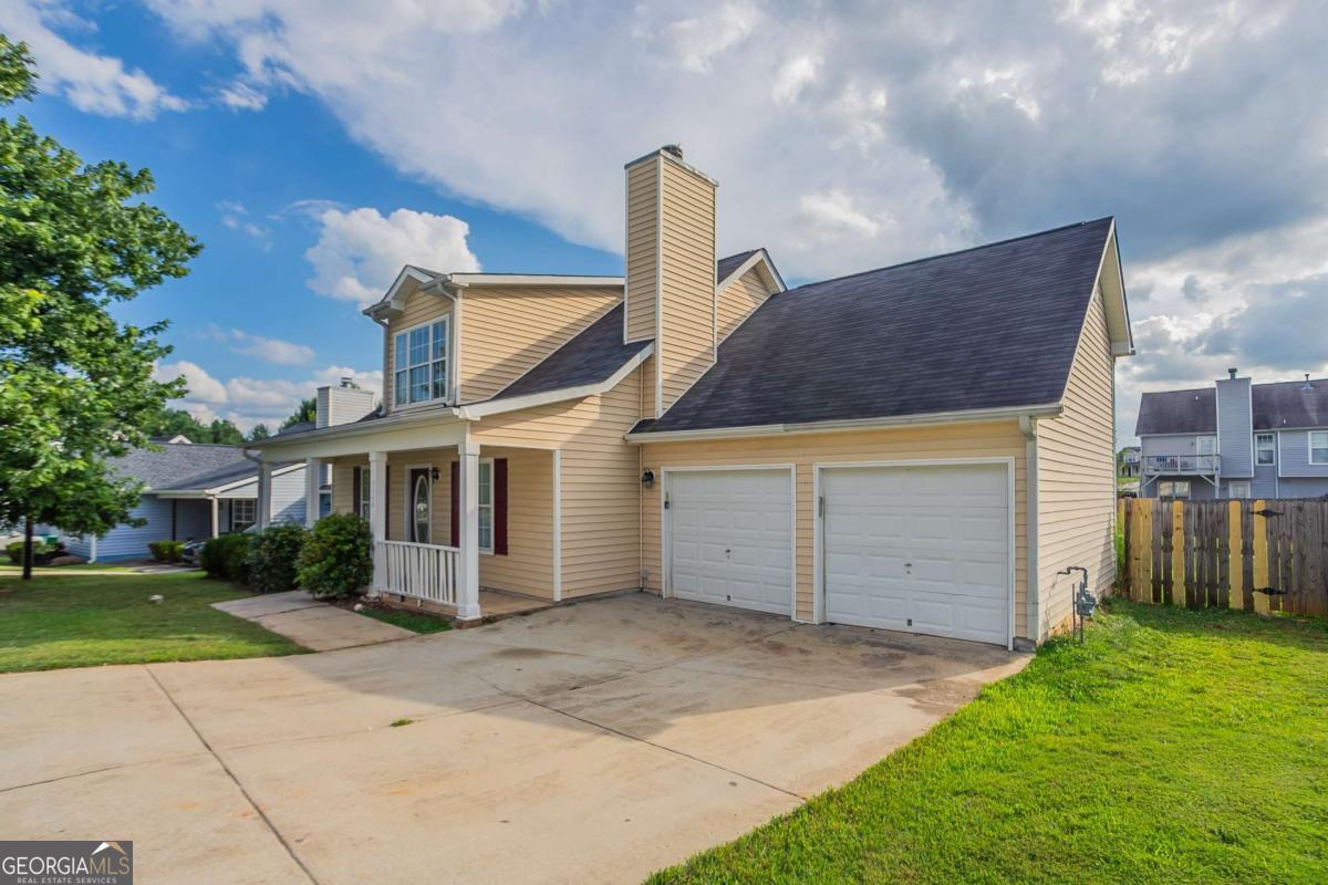 Welcome to this inviting 4-bedroom, 2-bathroom home nestled in the desirable Riverbend Overlook community. This residence offers a spacious and flexible layout with a separate dining room, a cozy living room with a fireplace, and a bright eat-in kitchen that opens to the keeping room-perfect for daily living and entertaining. The main-level primary suite features a walk-in closet and en-suite bath with a separate tub and shower. With its level yard and front porch for relaxing evenings, this home presents an excellent opportunity for first-time buyers or investors looking for long-term value. Discover the potential to personalize this home and make it truly yours.
