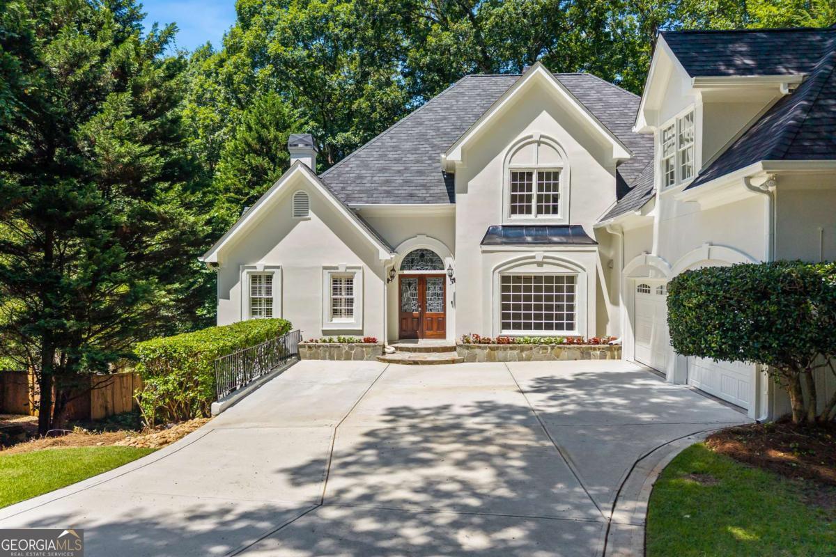 Tucked away on a quiet cul-de-sac in Roswell's sought-after Hadfield swim/tennis community, this beautiful and spacious home is the total package! Large square footage for the neighborhood with the master on main, a finished terrace level with a bed/bath, and a large, flat backyard perfect for kiddos to play with the option to add a pool! This home is an entertainer's dream and a personal retreat all in one. Inside, you'll find soaring ceilings, tons of natural light, charming trimwork throughout, a freshly painted interior, separate dining, family room and living room each with their own fireplace, and a spacious main-level primary suite with a walk-in closet, separate his/her vanities, a beautiful soaking tub by the fire, and private access to the expansive rear deck. The main floor also includes a half bath, hardwood flooring, and recessed lighting. The finished terrace level is ideal for multigenerational living, private office, or hosting out-of-town guests with a bed and bath, lots of additional storage, unfinished room that could easily be finished for an additional bedroom/office or kept as a workshop, and private access to the backyard oasis. Exterior is synthetic stucco but has been fully sealed and freshly painted. Located within one of Roswell's top-rated school districts and just minutes from Brookfield Country Club and Downtown Roswell. Schedule your showing today and make this home your own! Property is priced accordingly knowing that a buyer will likely want to do some cosmetic updates.