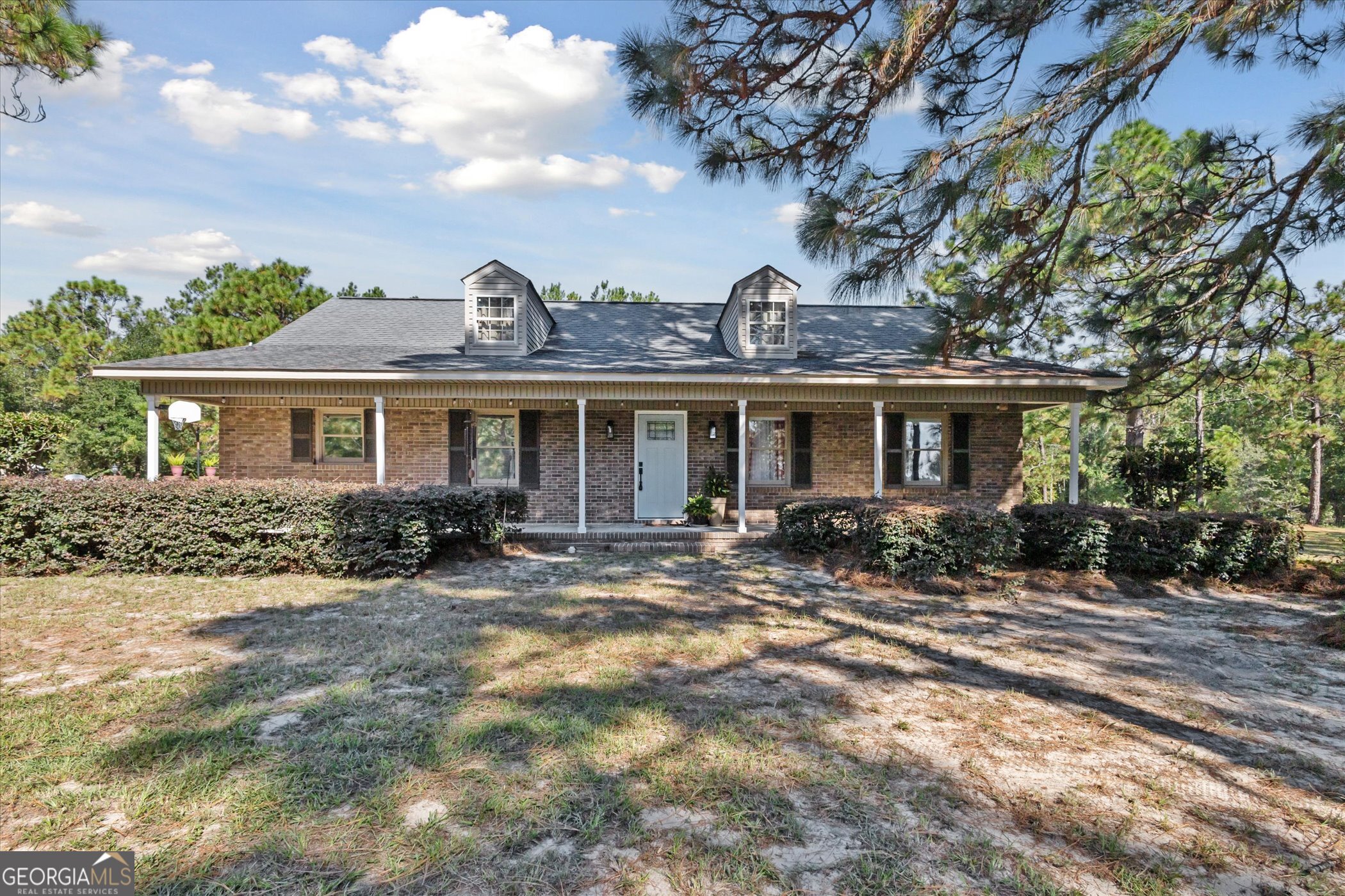 Discover the perfect blend of classic charm and peaceful country living with this beautiful 3-bedroom, 2-bath brick home on 5 sprawling acres. The property is fully fenced-perfect for animals-and includes a chicken house, a goat house, and a handy storage shed. Out back, an above-ground pool sits inside its own fenced area, and a freshly stained deck overlooks the private, tree-lined yard. Inside, the home offers a comfortable layout with generously sized bedrooms-including a welcoming primary suite-plus a functional kitchen, a dedicated dining room, and a cozy family room. Everyday practicality shines with a large laundry room and a convenient mud room off the back entry. Whether you're dreaming of gardening, a small hobby farm, or simply space to roam, this tranquil retreat delivers privacy and room to grow. Schedule your private tour today!