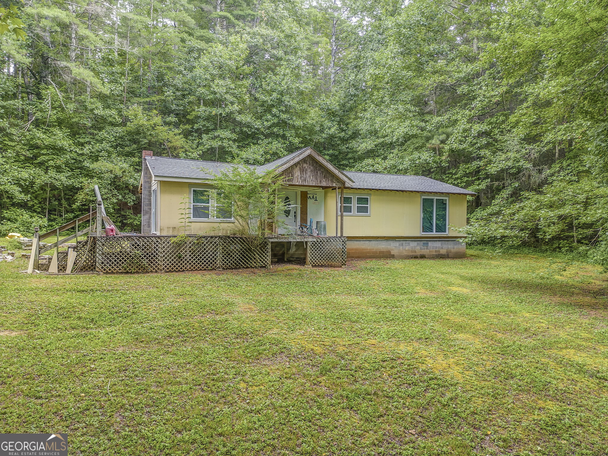 Investor Special with Endless Potential on 2.11 Acres! Don't miss this opportunity to make this 3-bedroom, 2-bath home your own! Nestled on a private 2.11-acre lot, this property is perfect for investors, DIYers, or anyone looking to customize their dream home. The hard part is already done - enjoy the benefits of a brand-new roof, windows, and doors, with most materials on-site and ready to complete the build. Featuring an open floor plan ideal for modern living, this home offers plenty of space and natural light. Located just 10 minutes from Downtown Ellijay and Chatsworth, you'll love being close to shopping, restaurants, wineries, and a variety of outdoor activities. An outbuilding adds additional storage or workspace, and the property offers a peaceful, private setting. Sold As-Is, but the seller is open to completing the project if you're in need of a builder. Endless possibilities await-come see the potential today!
