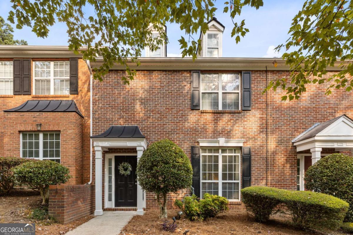 Welcome to this beautifully updated 3 bedroom, 2.5 bath brick townhome in the heart of Kennesaw, GA, offering 1,540 square feet of living space with big windows that fill the home with natural light and thoughtful upgrades throughout. Step through the front door into an oversized living room with soaring 9-foot ceilings, easily accommodating a 12-foot sectional with room to spare for additional decor or even a desk. It's the perfect space for both entertaining and everyday living. Tucked away in this room, a staircase leads upstairs while keeping the flow of the main level open and inviting. From the living room, continue into the kitchen and dining area, complete with granite countertops, stainless steel appliances, gas cooking, and warm under-cabinet lighting. A convenient laundry closet is located just off the kitchen, while the nearby back door opens to the covered patio and outdoor storage closet, steps from the private rear parking pad with two spaces. Upstairs, you'll find a well-planned layout with 8-foot ceilings. The primary suite offers a true retreat with his-and-hers closets, a soaking tub, and an upgraded standing shower with French door entry. Across the hall, two generously sized bedrooms comfortably fit queen-sized beds and share an updated full bathroom with a shower/tub combo. All bathrooms feature granite countertops, carrying the home's modern upgrades throughout. This home offers ample storage along with convenience and comfort. Throughout the property you'll find LVP flooring with no carpet, remote-powered fans with updated lighting, and smart-home technology including Ecobee and Nest thermostats, Ring doorbell and floodlight, and keypad entry locks on the back door and storage room. The home also offers dual-zone gas heating and cooling, allowing the upstairs and downstairs to be set at different temperatures for year-round comfort. Major systems including the roof, tankless water heater, and HVAC have all been upgraded within the past four years, and the HOA covers yard maintenance, termite protection, and water. Even better, this property offers an assumable FHA loan that covers more than half of the list price, giving qualified buyers a rare opportunity to secure more affordable financing. Located just minutes from Swift Cantrell Park, Downtown Kennesaw, Downtown Acworth, shopping, dining, and I-75, this is a rare opportunity to own an affordable, move-in-ready, smart-home-equipped townhome in one of Kennesaw's most desirable locations.