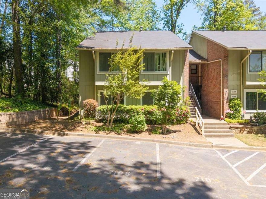 Tucked away in a quiet, secluded corner of a charming condominium community, this beautifully updated home offers peaceful living with the convenience of city access. Step out onto your private patio and take in the serene views of a lush, wooded retreat-perfect for birdwatchers or anyone craving a nature escape. Inside you will find stylish flooring, modern appliances, elegant tilework, updated gas logs, designer lighting, and completely renovated bathrooms. Enjoy the added touches like under-cabinet lighting with dimmers, new ceiling fans throughout. Despite the tranquil setting, you're just 1.5 miles from the Marietta Loop, a quick hop to I-75, and only 13 minutes from the Galleria and the Atlanta Braves stadium. Plus, you'll have the rare bonus of up to 8 parking spaces just steps from your front door-ideal for guests or multiple vehicles.