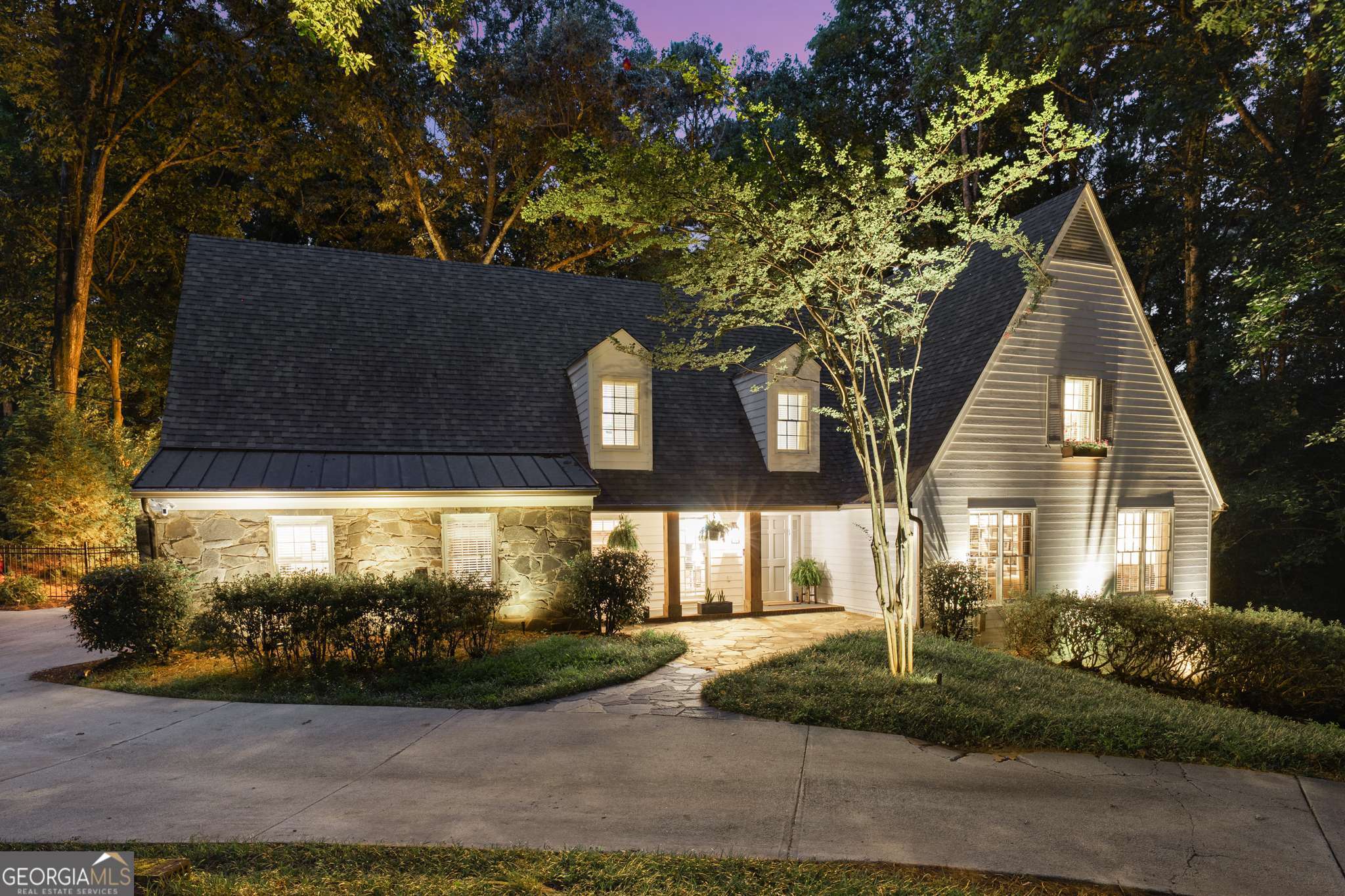 Ever dreamed of living on a golf course in a beautifully renovated home with timeless style and modern luxury? This stunning property in Huntcliff on the Chattahoochee sits on the 15th fairway of the Cherokee Town & Country Club and offers designer finishes, custom upgrades, and picturesque views. The kitchen was fully renovated in 2020 with natural quartzite counters, custom Wellborn cabinetry, walnut shelving, butcher block island, premium Viking appliances, and a spacious walk-in pantry. The adjacent mudroom and laundry feature quartz counters and matching cabinetry. Hardwood floors flow throughout the main and upper levels, complemented by elegant dining and living spaces and a cozy library. Two primary suites offer flexibility. The main level suite features travertine and marble finishes, dual closets, walk-in shower, and a makeup vanity. The upstairs suite, renovated in 2022, includes Carrara marble, zellige tile, RH fixtures, luxury shower, and a large dressing room. Secondary baths are equally refined with high-end materials. The finished terrace level adds stylish living space with new LVF flooring, an electric fireplace, private deck access, and generous storage. Recent updates include dual HVAC systems with UV germicidal lights, smart thermostats, WiFi garage doors, Hardie-style siding, copper lighting, and custom blinds throughout. Enjoy Huntcliff's resort-style amenities including an equestrian center, pool, tennis, clubhouse, private dock, and riverfront preserve. Minutes to GA 400, Roswell Road, and historic Roswell.