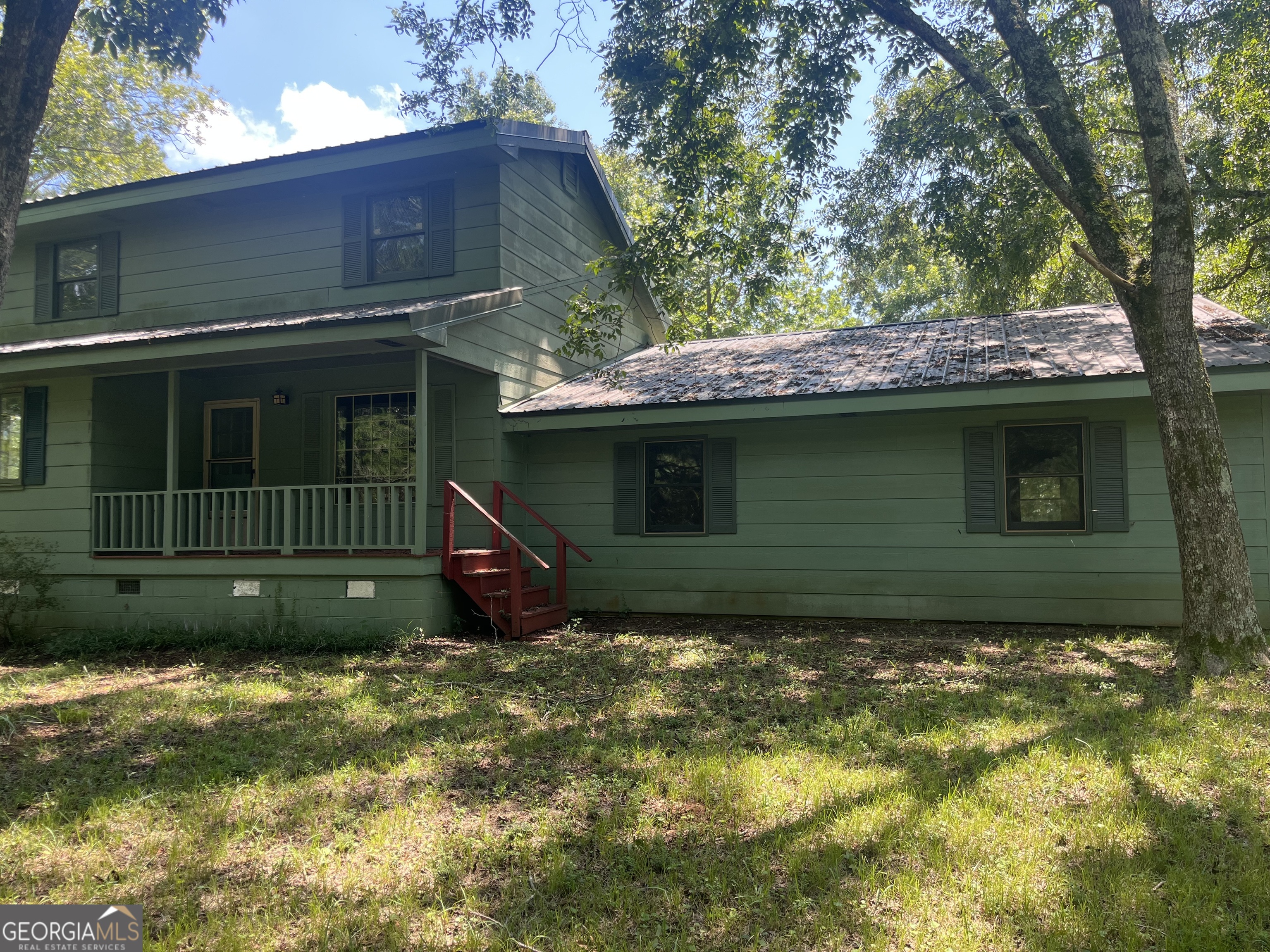 Charming 3BR/2BA Home with Handcrafted Touches on a secluded acre - Directly across from Watson Mill State Park Trails Tucked away on a peaceful one-acre lot surrounded by 74 acres of permanently protected land, this one-of-a-kind property offers unmatched privacy and natural beauty in the heart of Madison County. Located in the sought-after Comer Elementary School district, this 3 bedroom, 2 bath home is perfect for nature lovers, equestrians, or anyone seeking quiet country living with character. The spacious primary suite is conveniently located on the main level, and the standout feature of the home is the massive great room, partially constructed with hand-cut wood harvested directly from the property-a true rustic showpiece with warmth and craftsmanship you won't find in a typical build. Enjoy serene mornings and evenings surrounded by trees, wildlife, and the sound of nature, knowing your privacy is protected by the neighboring 74 acres that will never be subdivided. Step outside and you're just across the road from the horse trails of Watson Mill Bridge State Park. Don't miss this rare opportunity to own a home that feels like a retreat, while still being part of a welcoming community with an excellent local elementary school.