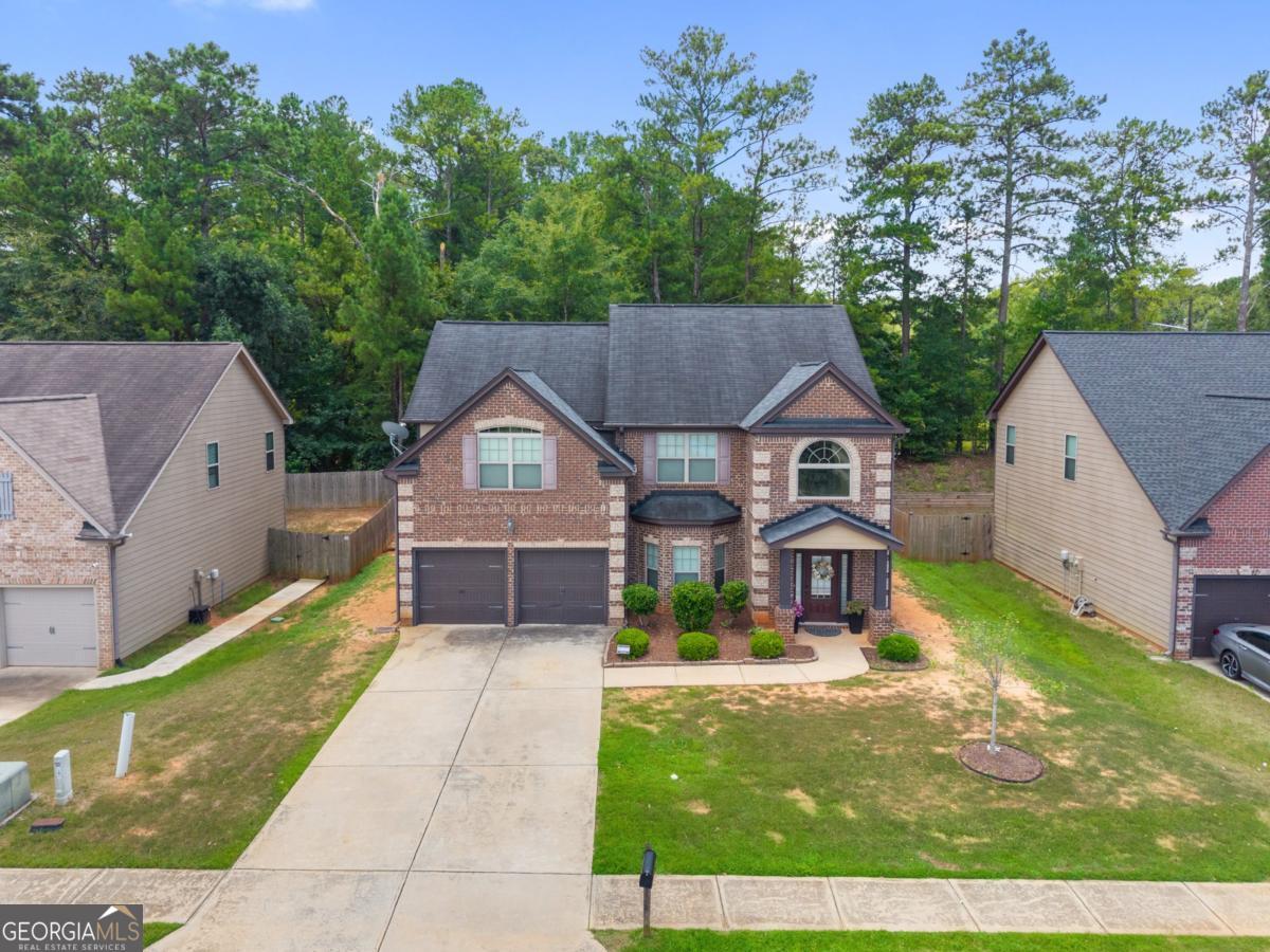 Discover comfort and elegance in this beautifully maintained home in Patriot's Pointe! Start your mornings or wind down your evenings in the peaceful, level backyard lined with trees and complete with a private patio, perfect for entertaining or relaxing. Inside, the heart of the home is the open-concept kitchen, featuring granite countertops, stainless steel appliances, and a center island, seamlessly connected to a cozy fireside family room ideal for gatherings. On the main level, you'll also find a formal dining room with coffered ceilings, perfectly set for special occasions, and a welcoming two-story foyer that makes a bold first impression. Upstairs, retreat to the oversized owner's suite, complete with a vaulted ceiling, generous walk-in closet, and a luxurious private bath that offers a spa-like experience. With 5 spacious bedrooms and 3 full bathrooms, there's plenty of room to grow, host, or create your ideal work-from-home setup. Whether you're looking for a primary residence or an investment opportunity, this home offers flexibility.