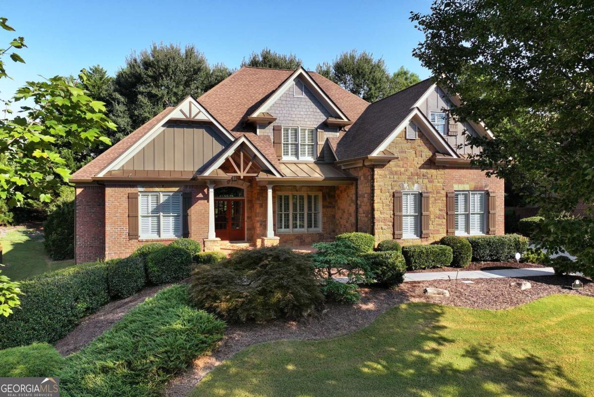 This stunning four-sided brick executive home offers over 4300 square feet of elegant living space, thoughtfully designed for both comfort and sophistication. At the heart of the home, the chef's kitchen showcases stainless appliances, custom cabinetry, and a generous island, seamlessly opening to the fireside keeping room and sunlit breakfast area. From here, step onto the charming, screened porch - the perfect retreat for morning coffee or evening relaxation. The luxurious primary suite is conveniently located on the main level and offers a sitting area with a cozy fireplace and built-in bookcases and opens to the covered back patio. The spa-inspired bath features a soaking tub, separate shower, and elegant finishes, while the walk-in closet with custom shelving provides the ultimate in organization and style. The inviting Great room showcases the coffered ceiling and statement fireplace with built-in bookcases creating the perfect space for gatherings and relaxation. Formal Dining Room, half guest bath and large laundry room with sink complete the main level. The upper level features three spacious bedrooms. One offers a private en-suite bath, while the other two share a full bath thoughtfully designed with separate sink areas providing comfort and convenience. Also up, are two expansive bonus rooms offering endless possibilities for a home theater, game room or private lounge. Enjoy a private, landscaped yard, offering both beauty and tranquility. Huge unfinished basement, fresh interior paint, Plantation Shutters, Hardwood floors throughout and much more! Top notch amenities in Hidden Falls include: Clubhouse, Pool, Playground and Tennis Courts. Conveniently located to all that Buford has to offer including shopping, dining, interstates, parks and Lake Lanier. Zoned for Seckinger HS and close to Buford City Schools. With soaring ceilings and custom details, every corner of this home exudes sophistication. This one-owner home has been meticulously maintained and ready for it's new owners.