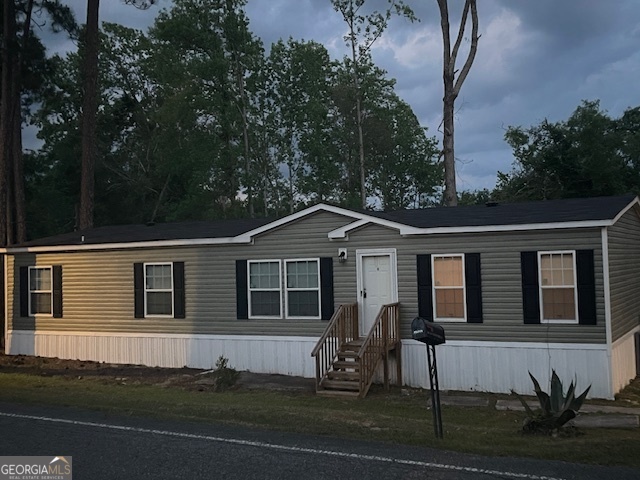 Cute and cozy 4 bedroom 2 bath Live Oak Model Plantation Doublewide nestled on 1.7 acre lot. Home has a gourmet eat in kitchen with island, great room with fireplace, spacious bedrooms, primary bedroom with primary bathroom, separate laundry room and lots of upgraded features. Private financing available.