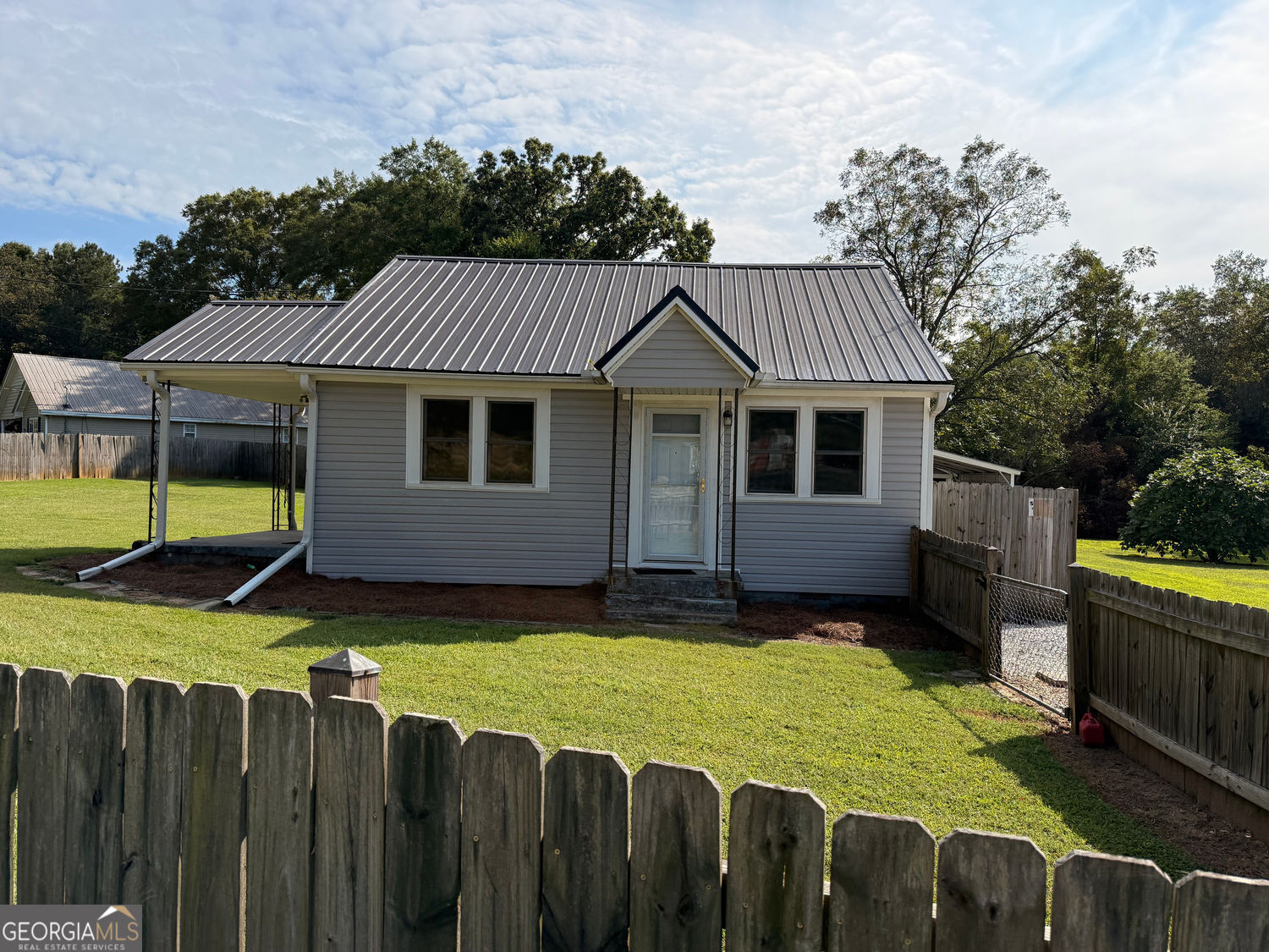 Don't let size fool you--this home packs a punch! Sitting proudly on a .64 acre fully fenced lot, it offers space, privacy, and extras you don't see every day! Enjoy 2 porches and 3 entrances and an impressive 3 garages for storage, cars, toys or workshop. A full kitchen renovation was just completed. This home features all new cabinets, appliances, light fixtures and fans, granite counters, new flooring throughout and a new hot water heater. Best of all, you are just minutes from Historic Downtown Monroe--where shopping, dining, coffee spots and community events are always around the corner. This is within the golf cart community, and a prime Monroe location.