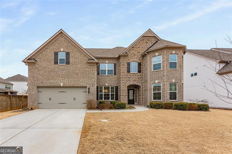 Highly sought after West Cobb neighborhood at Parkside Meadows community. Step into this beautifully designed traditional brick-front home with an elegant natural stone accent entry, offering both curb appeal and timeless charm. Boasting an open floor plan with 10-foot high ceilings on the main level, this home provides a perfect blend of spaciousness and style. The oversized master suite is a true retreat, complete with a large walk-in closet and a spa-like ensuite featuring a double vanity, separate soaking tub, and shower. Additional bedrooms are generously sized, while the media room offers the perfect space for entertainment or relaxation. The chef's kitchen is a dream, featuring solid surface counters, a large island, a pantry, and beautifully stained cabinets. High-end appliances include a gas cooktop, electric oven, microwave, and dishwasher, making meal prep effortless. The separate dining room is ideal for hosting gatherings, while the luxury vinyl flooring adds both elegance and durability throughout. Spacious fenced backyard, great for your family pets to roam around and enjoy. Enjoy your weekend BBQ under the large overed patio porch.