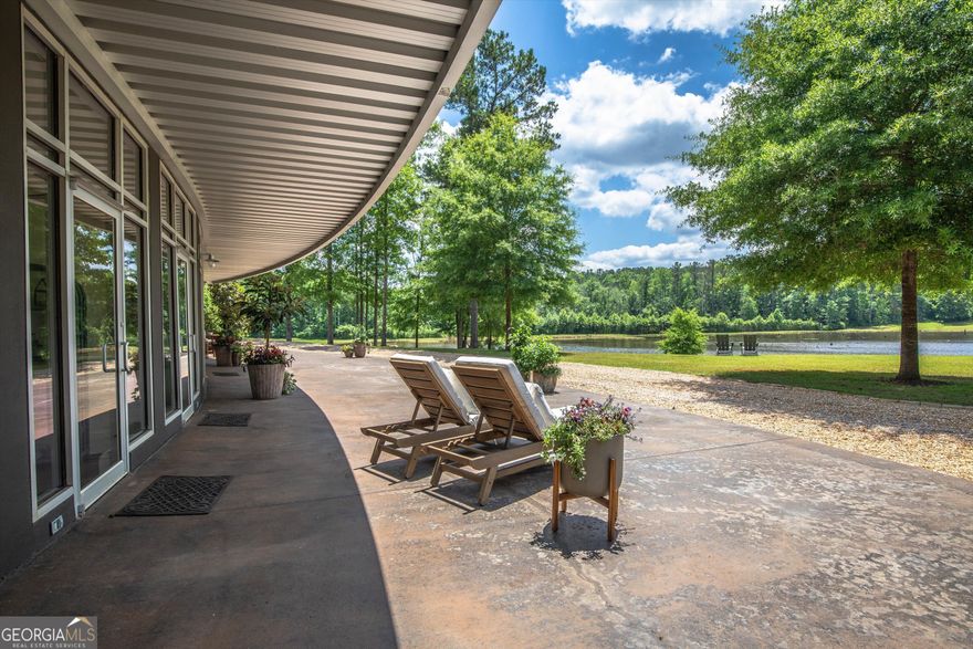 Rare estate property just a short drive from Auburn University!  The ultimate all-inclusive property, Sandy Creek Estate features a primary residence and guest house, 82 manicured acres perfect for entertaining, fishing, hunting, atv riding, and sunset viewing. The showstopper is the main house which overlooks a collection of private ponds!  Built into the side of the hill with floor to ceiling picturesque views from nearly every room the industrial designed home brings the outdoors in. The kitchen showcases custom cabinetry, granite countertops, and new high-end appliances including double ovens and a built-in ice maker.  The split floor plan offers a master suite and 3 additional bedrooms with incredible views.  The 9 acre stocked trophy bass pond is the fisherman's dream, with 5-6 lb bass common place and the record pond catch being an 11 pounder!  Not to be outdone the separate stocked catfish and brim pond keeps your line tugging at every cast!  Hunting opportunities for deer, turkey and dove have been cultivated with green fields, built in blinds, and strategically placed trail systems. The secondary residence is a 1500 sq. ft. cabin featuring stained wood siding with stunning views off a covered wrap around porch. Built in 2018, the cabin's heart pine floors, solid wood doors, and ample windows create a continued flow between the indoor and outdoor spaces.  Below the cabin sits a 1500 sq. ft. walkout basement shop, perfect storage or use as a traditional workshop or game room area. Tucked into the woods a Pole Barn gives ample storage for tractors, boats and ATV's.    Located approximately 20 minutes from Auburn University and Lake Martin and just over 1.5 hours from both Atlanta and Birmingham, this estate's location is perfection!    One of a kind with opportunities abounding, come and see Sandy Creek Estate!