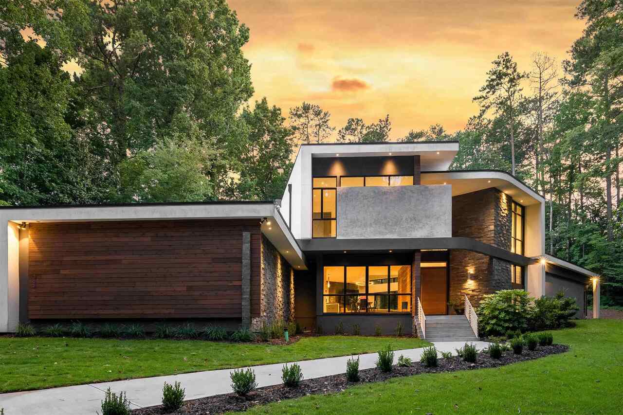 Breathtaking Contemporary Estate, built and designed by" Flux Architecture + Design" in the heart of North Buckhead. This home is perched high on a private 1.6-acre lot complete with a long private driveway and immaculate landscaping. The awe-inspiring exterior features a slate stone veneer, smooth cement stucco, a solid core birch Pivot front door, and Floor to Ceiling Pella windows. This chic sanctuary offers high ceilings up to 28 ft, a dramatic 3-story staircase, and an open floor plan filled with tons of natural light. This flexible floor-plan is complete with the owners suite & a guest bedroom on the main level, three bedrooms w/ private baths, private balcony, and a bonus loft overlooking the Atrium. There are multiple flex wings perfect for entertaining guests and a finished terrace with a recreation/media area & private bath. The custom European kitchen boasts Miele appliances, Sub-Zero refrigerator, Cambria countertops w/a large island, AND best of all a walk-in pantry/prep area perfect for gourmet chefs. Your eyes will be drawn to the living room complete with sliding Pella doors bringing the outdoors in, a driftwood/ river rock fireplace, and custom built-ins. The owners suite has sliding glass doors leading to an outdoor patio and a double-entry custom closet system. The spa-like owner's bathroom features an incredible rain shower with high-end European tile with tall specially-tailored glass panels and a separate soaking tub. The outdoor living space is ready to entertain guests with an outdoor kitchen overlooking your own private oasis that has plenty of room for a POOL!