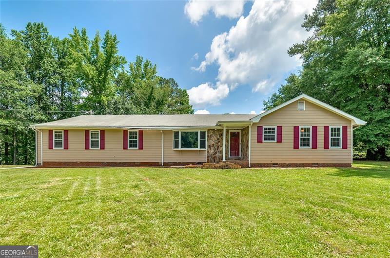 This beautifully renovated 3-bedroom, 2.5-bath ranch-style home sits on 1.10 acres. With NO HOA and modern updates throughout, your perfect retreat awaits. Step inside to see your foyer, formal living room, formal dining room, a huge family room with a gas and wood burning fireplace, a kitchen, large bedrooms, and more. The family room has brand new can lights. This entire home has been upgraded with luxury vinyl floors and fresh paint in vibrant bright colors. This home has a brand-new kitchen with new granite countertops, new stainless-steel appliances, new farmhouse sink, new gooseneck faucet and new white cabinets. A sunroom with a handicap accessible ramp provides a serene spot to unwind after a long day at work or early mornings. The huge bedrooms offer plenty of space. This property has new bathroom vanities with granite countertops. Every detail has been carefully considered, from new faucets, towel bars, toilet paper holders, handicap toilets and updated bathroom lighting. The HVAC system is brand new, as is the ductwork and thermostats. For those with larger vehicles, you'll love the oversized automatic garage that can accommodate a truck or SUV. The garage motor and opener are also brand new. Plus, there's a handicap-accessible ramp in the garage for easy access. Outside, enjoy a large storage building, a 2-car carport, and plenty of space to garden, host family events, or just relax in your very own private oasis. The septic tank was recently cleaned in 2025. This property offers the space, serenity, and functionality you need for a peaceful lifestyle. This home is SOLD AS-IS. and the seller is looking to work with a serious buyer for a successful closing. Don't miss your chance to fall in love with this peaceful haven. Schedule your showing today!