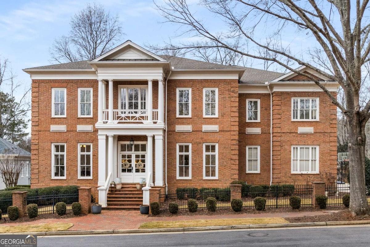 Charleston meets Atlanta In this stunningly-renovated Antebellum replica. Located in the picturesque, gated community of Ellard in East Roswell, this all-brick masterpiece hearkens to days gone by where quality construction and craftsmanship were the standard, not an option. Enjoy all-brick construction, soaring 12-foot ceilings, abundant natural light, beautifully refinished hardwood floors, crisp white paint and incredible millwork throughout. The thoughtfully renovated interior will allow you to move right in and instantly begin enjoying your new home without the woes of a major project. The covered front porch of the home greets you as you overlook one of the neighborhood's multiple park areas upon arrival. A two-story foyer and curved staircase are the perfect welcoming details. Flanked by a large formal dining room and formal living room (or ideal office space), you'll feel as though you've stepped back into the entertaining spaces of a bygone era but with updated, modern touches. A gorgeous chefCOs kitchen is the heart of this home with an open-concept layout thatCOs perfect for daily life and soirees alike. Luxury appliances, honed quartz countertops, a marble backsplash, a massive amount of white cabinetry and even a dog watering station make this a space in which you'll love spending time. The butler's pantry and large walk-in pantry are added conveniences. The main level is completed by a stunningly renovated powder room, molding-clad bedroom and full ensuite bath, a huge new rear porch with composite decking and an oversized 3-car garage. Retreat to the "sleeping quarters" of the home upstairs where you'll find the primary suite with a sitting room, wet bar, dual walk-in closets and a stunningly redesigned marble-clad ensuite bathroom that evokes the feel of the most luxurious spa. All bedrooms feature triple tray ceilings, ensuite baths and walk-in closets with custom closet systems for ultimate comfort and convenience. The remodeled laundry room is also conveniently located on this level. Take one of the two staircases back down to the main level and on to the finished basement where you'll find new LVP flooring throughout, a massive open-concept living/game room, custom wine cellar, media room, home gym, bedroom, full bath and ample storage. Your flat, sprawling backyard oasis has plenty of room for play and includes a fire pit and gorgeous flagstone patio. Contrary to many of the homes in the neighborhood, this one overlooks a private wooded area with walking trail - the perfect spot to enjoy nature at its finest. Ellard is a community of replica homes designed after Antebellum estates in Charleston, Savannah and New Orleans. There's nothing else like it in Atlanta! In addition, the neighborhood features unmatched amenities such as 24/7 guard-gated access, tree-lined streets with brick sidewalks on both sides, a stunning conservatory, 4 tennis courts, a swimming pool, basketball court, playground, community gym, Chattahoochee River park, walking trails, acres of greenspace and lots of social events throughout the year. Ellard is conveniently walkable to tons of restaurants, retail and parks and just a short drive to top-rated area public and private schools in addition to major highways.