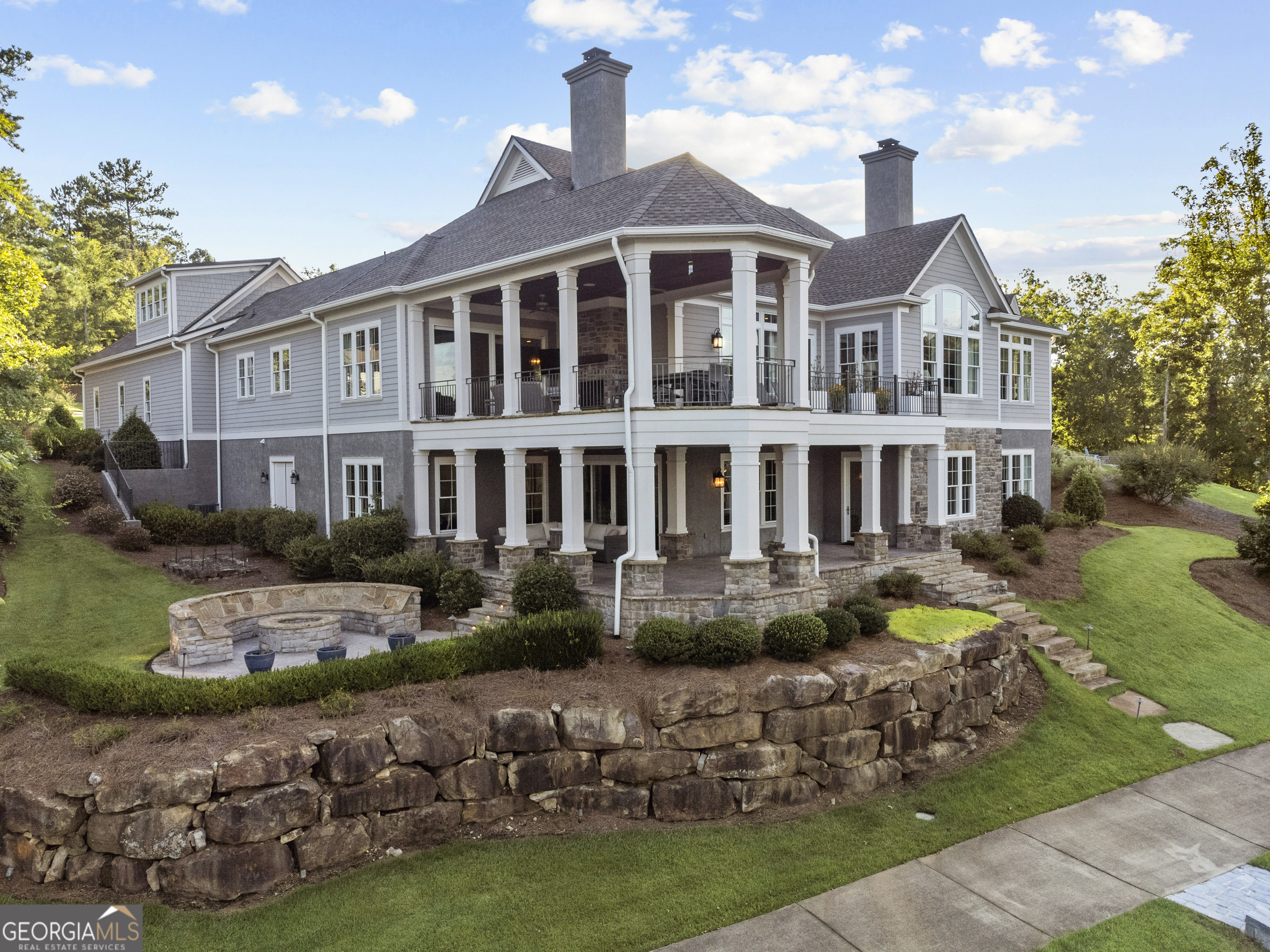 Stunning "Like-New" Lakefront Custom Home in Reynolds Lake Oconee nestled on almost an Acre of Prime Property ! Move right into this pristine lakefront home in Reynolds Lake Oconee, offering expansive water vistas in a private, tranquil setting. Spanning over 5,700 sq ft, this rarely-used lake home is as good as "new" with 5 bedroom suites and 5.5 baths and incredible views. A long, meandering driveway welcomes you to the front door. Inside, you'll be impressed with the open floor plan with a vaulted ceiling and a stone fireplace in the great room giving you front row view of the lake and sunsets. The dining area seamlessly connects to the well-appointed Chef's kitchen which features stainless steel appliances, a full bar with ice maker and a beverage fridge. Adjacent to the kitchen, a spacious hearth or sitting area opens to an expansive and relaxing porch with the outdoor grill and fireplace overlooking the lake. Conveniently located next to the large laundry room is a built-in office space. Above the three-car garage is a spacious apartment suite with a private bath, perfect for guests.The main level features a large primary suite with stunning water views, luxury bath and walk-in closet. The expansive terrace level will impress you with the spacious family and TV room, a billiard and game room complete with a custom bar, and three additional large suites with private baths. Walk out to the gorgeous second deck and stone patio to take in the sunset and setting, then descend to the stone steps to your outdoor firepit or private boat dock.There is a large storage area and conditioned unfinished space. The home boasts a stone seawall and stone steps leading to the dock, providing access to Reynolds' only walking trail along the lake. Ideally located near the main security gate and other Lake Oconee amenities, including The Ritz-Carlton, this home offers the perfect blend of luxury and convenience. Don't miss your chance to own this beautiful custom lakefront home in Reynolds Lake Oconee. Move in tomorrow and start living your dream today. Membership to the Reynolds club is available.