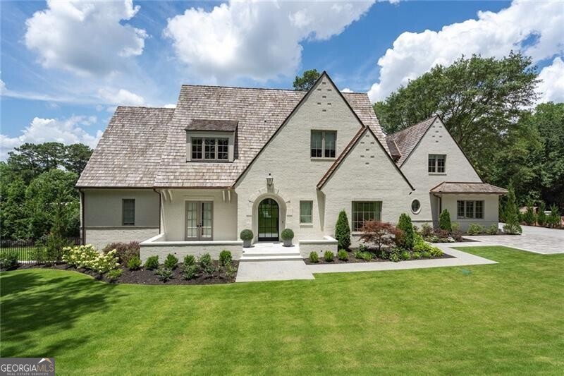 Nestled within the picturesque neighborhood of Chastain Park, lies the enchanting newer construction home at 4514 Stella Drive, located on one of the most popular streets. This home was custom-built by Crestar Homes in 2021 and leaves no detail behind. As you enter the home, the foyer is flanked on either side by an office/study and the formal living room. The beautiful chef's kitchen with a large center island, high-end appliances, walk-in wine cellar and custom breakfast nook overlooks the fireside beamed family room. Adjacent to the breakfast nook is the large separate scullery with sink, second fridge, ample storage and prep area. The living room has tall ceilings and iron doors leading to the covered patio complete with grill, retractable sun screen, heaters, fireplace and TV. The exteriors of the home are beautifully landscaped and feature a pool and spa and a turfed area for play or dogs. The oversized owners suite is also located on the main level and has an incredible spa bathroom complete with two vanities, separate tub and shower, his and her closets and a stackable washer and dryer for easy convenience. Upstairs are four bedrooms, each with their own en suite bathrooms. One of the bedrooms is located over the garage and would make a great in-law/nanny suite. The basement is complete with gaming and tv areas and one bedroom and bath. Discover the epitome of luxury living at 4514 Stella Drive, where every detail has been thoughtfully curated to exceed expectations.. With close proximity to the amphitheater, pool, tennis courts, horse park, golf course, and the popular restaurant, The Chastain, this neighborhood has it all.