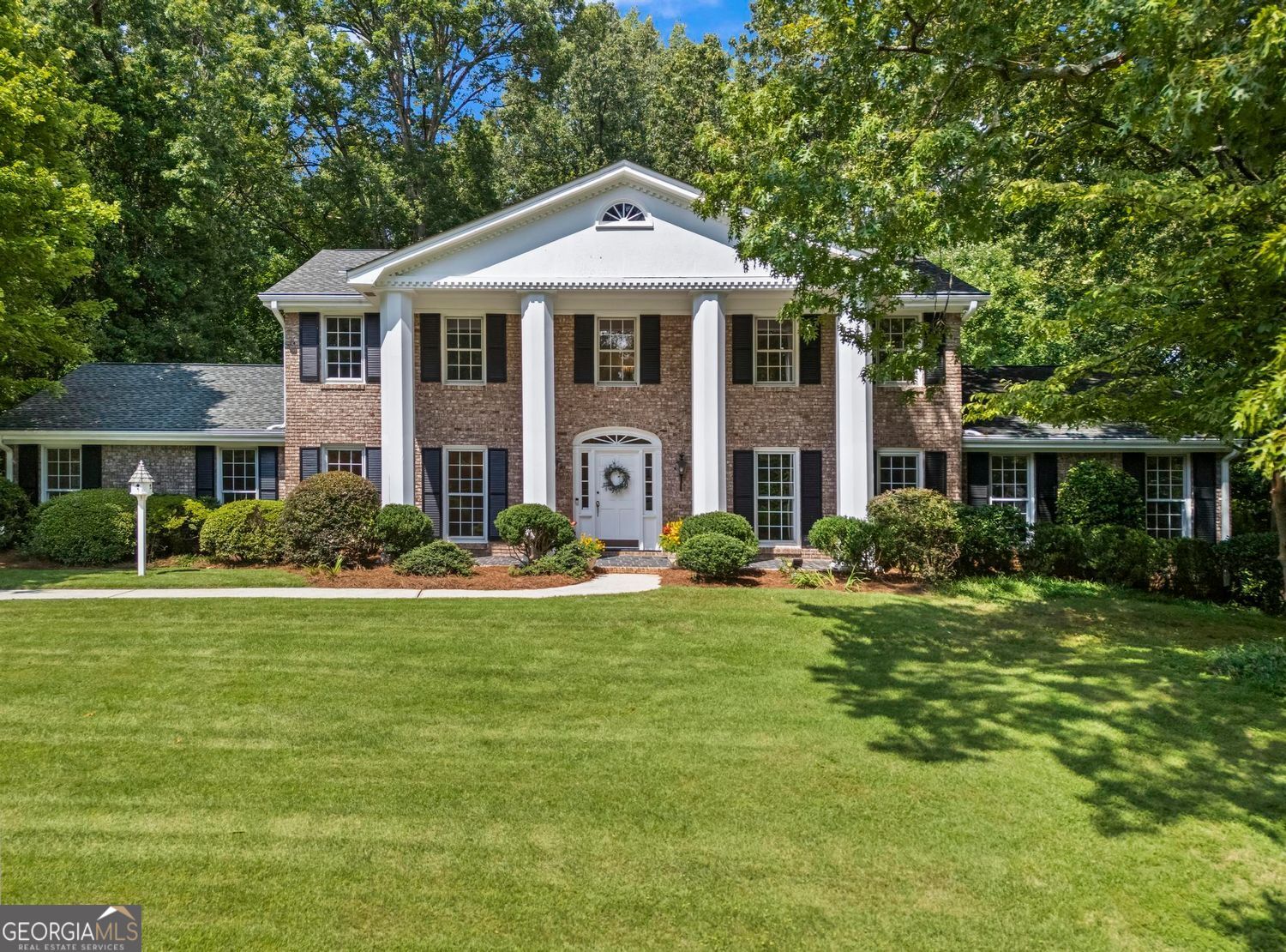 Welcome to this stately 4-bedroom, 3.5-bath colonial in sought-after Riverwood Charter School District-an exemplary classic of the fine-quality homes built in its era. Whether you are a family eager to create your dream home while living in it, a designer with a vision, or a builder seeking a prime renovation project, this property offers endless possibilities. With its authentic hardwood flooring throughout, bold dentil molding, sweeping staircase, and elegant chandelier, this home embodies all the luxury features known for its time. Large rooms, floor-to-ceiling windows, a generous kitchen space, a wet bar, and ample recreation areas give the home an upscale feel while also providing plenty of room for entertainment. You'll love having the choice of a primary suite on the main floor or a primary suite upstairs, reserving the first-floor bedroom as a guest room if desired. Many big-ticket updates have already been completed, including fresh interior paint, electrical updates, a waterproofed basement, encapsulated crawl space, and a newer roof, HVAC, and water heater-providing a strong foundation for your cosmetic vision. The original 2-car carport has been renovated into a spacious family room, which can easily be converted back to a garage if preferred. Nestled in a charming Sandy Springs neighborhood within the top-rated Riverwood Charter School district, this home's timeless layout flows beautifully. It includes a full, daylight, exterior-entry unfinished basement ready for your creativity and offering countless possibilities. Set on a large private lot with mature landscaping and a prime location near shopping, dining, parks, and major highways, this opportunity in Sandy Springs is truly a must-see for anyone seeking timeless character, modern updates, and endless potential.