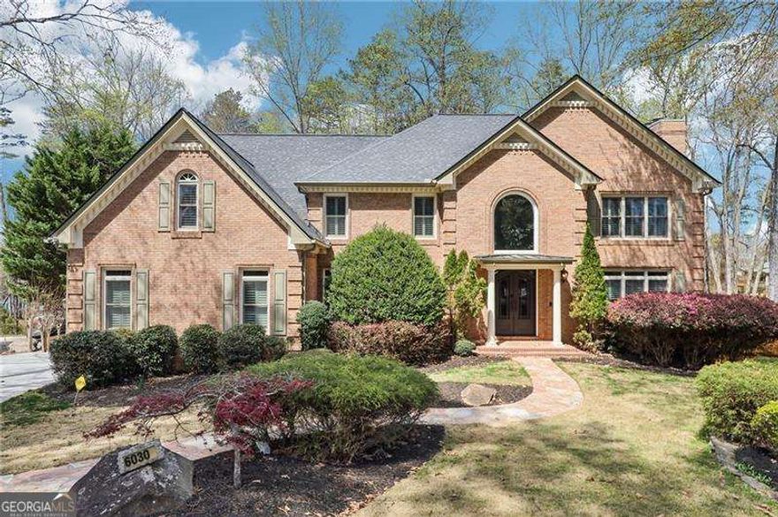 SELLER FINANCING AVAILABLE. Welcome to this stunning 6-bedroom, 5-bathroom LAKE LANIER HOME on a FINISHED TERRACE, with TWO KITCHENS, 3 fireplaces, SUNROOM, PARTY DECK with BOAT LIFT, and over $100,000 in renovations!! Located in a quiet CUL-DE-SAC this spectacular property boasts an expansive 4-CAR GARAGE, extended parking pad, and lush established landscaping, maintained by a convenient irrigation system for year-round curb appeal. The driveway has recently been refinished! Surrounded by seasonal foliage, this home offers a private oasis with breathtaking views of the lake. As you enter, a grand curved staircase sets the tone for the elegant two-story foyer. The classic study provides the perfect setting to display your book collection, unwind with a quiet read, or a work from home office space. The spacious formal living and dining rooms feature custom built-ins and a fireplace, creating an inviting space for entertaining. French doors lead from the dining room to the expansive deck. The custom fully renovated kitchen is a chef's dream, equipped with high-end appliances, a large island, exquisite lighting and fixtures, and a PANORAMIC LAKE VIEW as you prepare meals. Palladium and transom windows, along with skylights and a WALL OF WINDOWS in the great room, flood the home with natural light, showing off the gorgeous hardwood floors throughout. The great room also features a floor-to-ceiling stacked stone fireplace, bar area with wine fridge, and a SECOND STAIRCASE for added convenience. Relax in the sunroom and bask in the outdoors no matter the weather. The LUXURIOUS PRIMARY SUITE features vaulted ceilings, French door entry, deep soaking tub, double vanity, and spa life fixtures including the huge walk-in shower with rainfall shower head and BODY SPRAY JETS! The show stopping closet has custom built-ins, chandelier, and a washer and dryer! Perfect for unwinding after a long day. This home exudes character and charm with plantation shutters, extensive craftsman work, and thoughtful design details that flow seamlessly from room to room. The FINISHED TERRACE LEVEL serves as a true extension of the home, offering endless possibilities for in-law or guest quarters, or the ultimate entertainment area. It includes a second kitchen, fireplace, MEDIA ROOM, sound system, intercom, bedroom and full bathroom, bar, BONUS SPACES, FITNESS ROOM, and ample storage. Multiple French doors lead to the beautifully landscaped backyard, where you'll find a flagstone-covered patio, SCREENED-IN PORCH, artificial turf, and stairs that lead directly to the main deck and sunroom, making it easy to mingle. Escape to the GAZEBO and soak in the HOT TUB, or take a short level walk down the lighted pathway to the COVERED BOAT SLIP with a HYDROHOIST SYSTEM, and two jet ski ports offering deep water access at all times. DOCK IS PERMITTED. After a refreshing day on the lake, the sizzle of your favorite meals fill the air from your outdoor kitchen that is fully equipped with a griddle, grill, power broiler, and sink. With summer just around the corner, your lakefront lifestyle awaits. Whether you're hosting parties on the party deck, enjoying days on the water, or relaxing while watching the sunset, this home offers the perfect balance of luxury and leisure. This dream home you've been waiting for HAS IT ALL. Seller is offering $10,000 closing cost incentive. Make Lake Lanier living your reality!