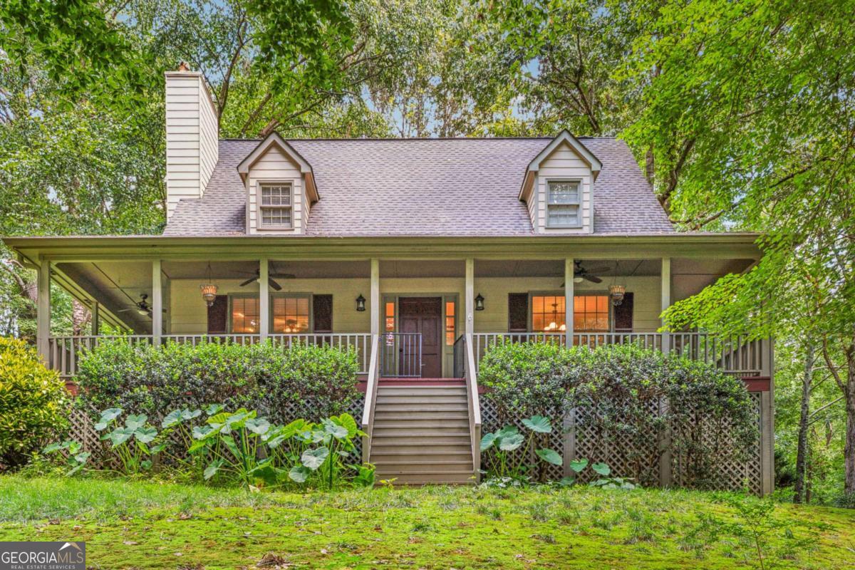 Assumable loan at 3.125% rate - This isn't your run-of-the-mill suburban home - it's a front porch craftsman cottage with personality. Down a picturesque driveway, the home is tucked in what feels like a park-setting. Located in Springfield Place subdivision, this 3 bedroom, 2.5 bath home feels like a vacation escape but keeps you close to all the conveniences of Woodstock. The primary suite is on the main level, complete with a beautifully renovated bath Pinterest-style bath and walk-in closet. Convenient access to the wrap around porch is right off the primary suite - perfect for morning coffee or taking the dogs out. The living room gives you cozy fireside vibes, and the kitchen has newer appliances, and all the conveniences, with a little bit of rustic charm. Upstairs you've got your pick - two large bedrooms flank another full bath with skylight. Outside, the yard is big, green, and shaded - perfect for a trampoline, firepit nights, or just hanging out under the trees. There's also a partially finished, daylight basement and a two-car garage for all your gear. Currently a workout space, this has been a workshop (with convenient double door access leading directly to the garage. Also - there's a fantastic office with a door right out to the driveway. No need to walk around to the front door if you're working from home, or need to step out for a call and some fresh air. The best part? Springfield Place is a swim/tennis neighborhood, and you're minutes from Downtown Woodstock, trails, concerts, shopping centers galore, and everything else that keeps the city buzzing. Think cottage charm meets neighborhood living - and yes, it's just as good as it sounds.