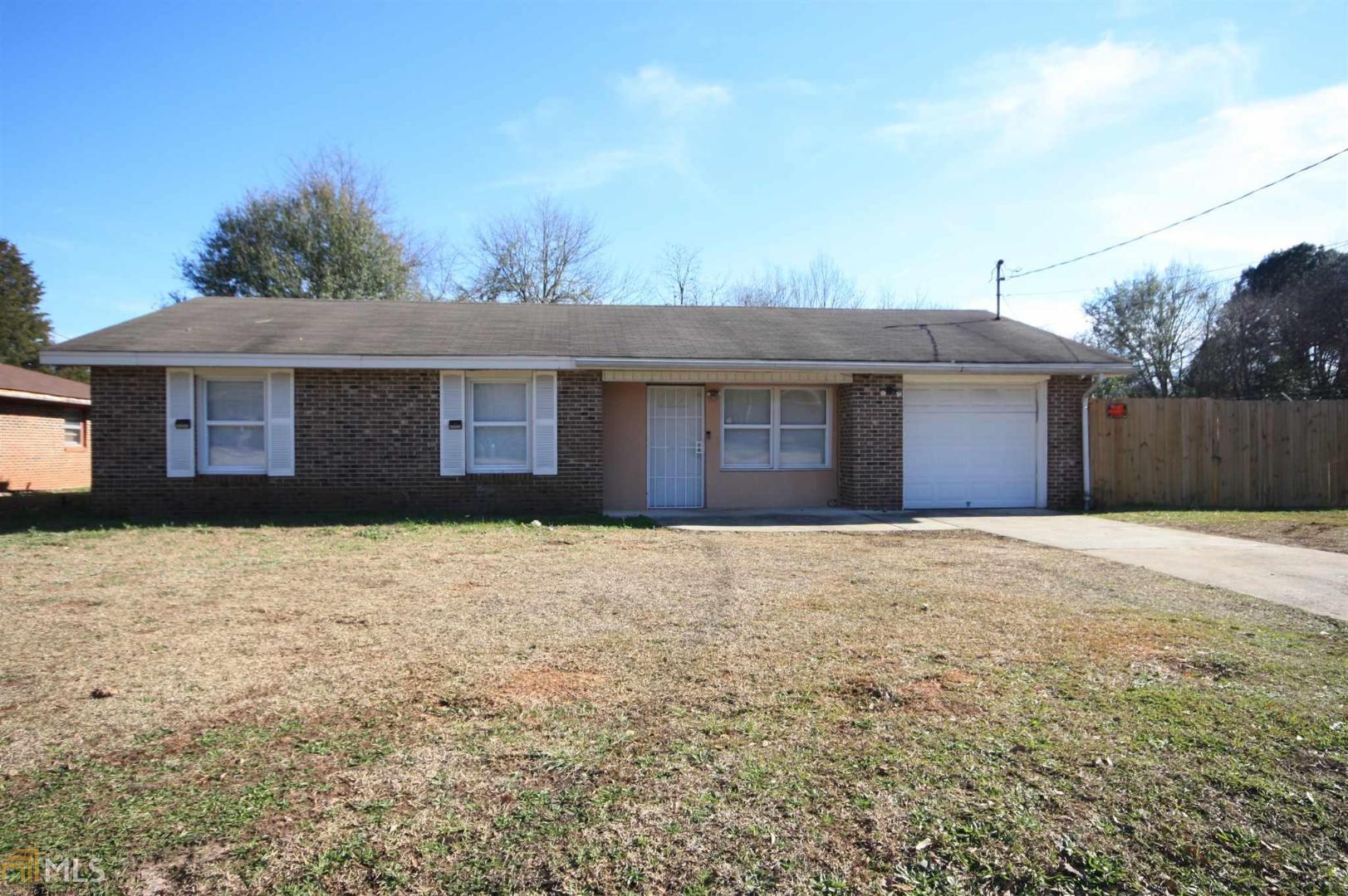Stop Paying Rent NOW! Laundry in garage, Kitchen measurements include Dining area, cozy fireplace in kitchen, stainless steel appliances, large fenced back yard.