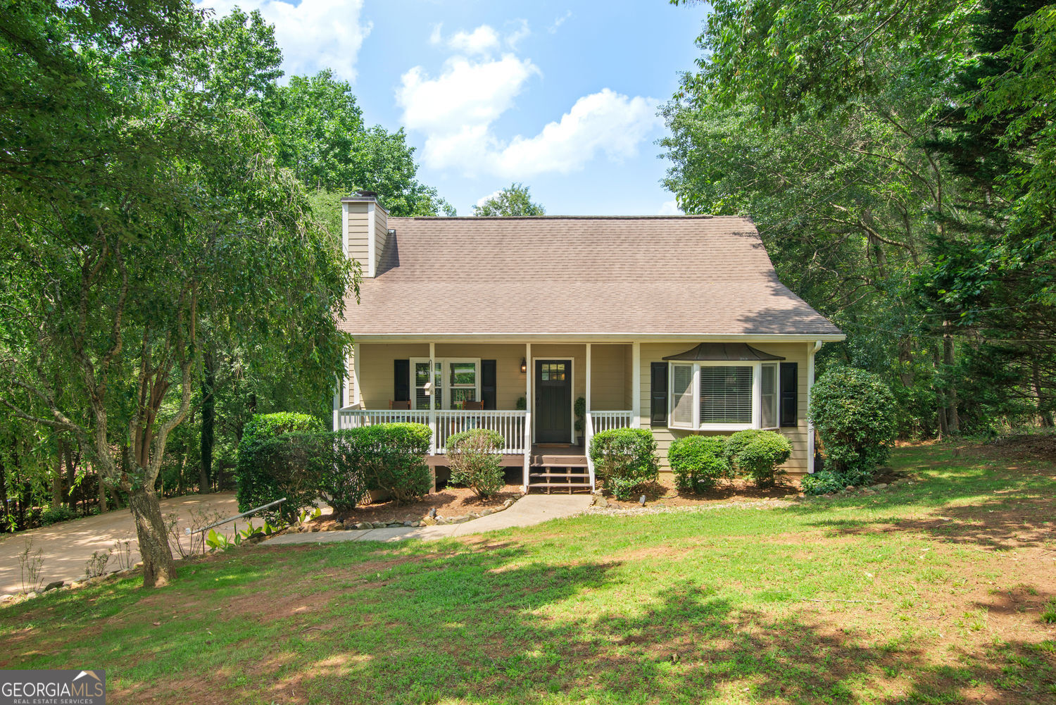 JUST LISTED! You can't beat this location. Minutes to the booming and growing downtown Woodstock, but far enough away to enjoy the quiet! This home has the primary suite on the main level with two additional bedrooms and a bath on the second level. The great room and large kitchen are an open concept with stainless appliances and granite counters, so this home is perfect for entertaining. The terrace level features an oversized garage with plenty storage and workshop. Rear deck that overlooks the private wooded 1.1-acre lot and goes past the tree line. This home is truly a gem, well maintained and move in ready! This beautiful home is in a community with NO HOA and in a great school district. You won't be disappointed...