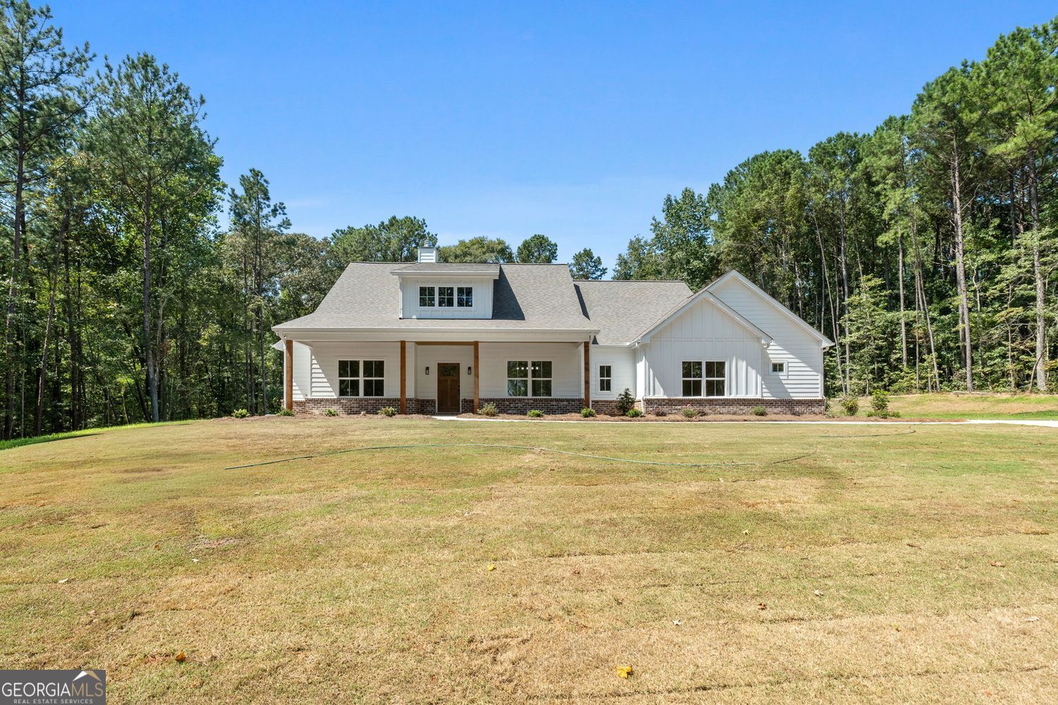 This is a HOT one! Lot 7 English Road - New construction ranch on 6.27+/- private acres in Forsyth (Monroe County). No subdivision or HOA here! Take the winding driveway to your personal piece of private serenity! Approx 2,263 +/- square feet of living space all on one level offering 4 bedrooms and 2.5 baths. This wonderful floorplan features dedicated spaces, but in an open floorplan so they flow easily with 9' ceilings and vaulted ceilings throughout. There's a formal foyer entrance, a formal dining room that opens to the family room with fireplace, and a spacious island kitchen. The dining room features beautiful molding detail. The family room is vaulted and offers plentiful windows and natural light with a brick fireplace with cedar mantle and access to the large rear covered back porch. The kitchen features a huge walk in pantry, real wood cabinetry with soft close hinges, an island, large picture window overlooking the backyard, upgraded granite countertops, tile backsplash, custom venthood, and stainless steel appliances, including a built in oven, separate cooktop, built in microwave, and dishwasher. Laid out in a split bedroom plan for privacy, the primary suite is a beautiful suite and features a vaulted ceiling in the bedroom, ensuite bath with tile floor, large tile zero entry walk in tile shower with framed glass door, separate soaking tub with tile surround, separate vanities with upgraded granite countertops, and a huge walk in closet with access to the laundry room. The laundry room itself is huge and is accessed from both the primary suite closet and the rear hallway, has cabinetry, a utility sink, and ample room for additional furniture/shelves/or storage. The secondary bedrooms have their own private hall on the opposite side of the home, all have walk in closets, and share a full bath that offers a dual sink vanity and a separate wet room. Other features include a rear entry into the home from the garage with a separate foyer area with a built in utility bench and a half bath for guests. The home features black & oil rubbed bronze fixtures and hardware and LVP flooring throughout the entire home. The exterior offers a brick water table on the front and sides, board and batten accents, sturdy Hardie siding, and rustic wood planked ceilings on the covered front and rear porches. You can truly sit and enjoy the peace, quiet, and nature here. Dedicated sodded yard space and the remaining acreage is wooded in pretty hardwoods. Conveniently located less than 5 minutes from I-75, making this a slam dunk for commuters, yet it feels away from it all. Convenient to the quaint downtown Forsyth square, where there are great local small businesses and restaurants and many local community events are held. Other modern conveniences are nearby (gas, grocery, etc). Sought after Monroe County Schools (KB Sutton Elementary, Monroe Middle, and Mary Persons High School). Use the preferred lender and receive 1% of your loan amount to use towards closing costs, pre-paids, and/or rate buy down. Home is in the final stages of completion and can close in 30 days or less. Builder provides a 2/10 home warranty.