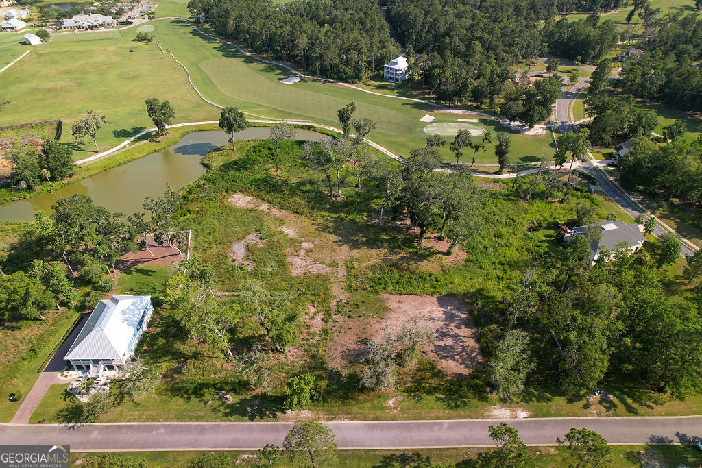 Discover one of the rarest offerings in the coveted Sanctuary Cove community - a spacious double lot totaling .46 acres, thoughtfully combined under just one HOA fee. This exceptional homesite overlooks the tranquil lagoon and offers views of Hole 1 on the championship golf course designed by Fred Couples and Davis Love III, providing the perfect backdrop for your dream home. Sanctuary Cove is a gated, resort-style community offering top-tier amenities including a riverside clubhouse, pool, tennis courts, fitness center, and access to the Little Satilla River via a private day dock. With easy access to I-95, you're perfectly situated between Savannah and Jacksonville, and only minutes from the charm of Historic Brunswick and the beaches of St. Simons and Jekyll Island.