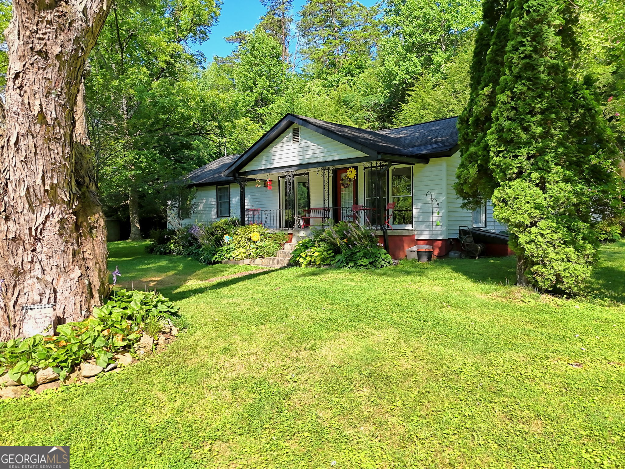 Discover the charm of the Blue Ridge mountains living in this inviting 3 bedroom 2 bath with a bonus room one-story country home, perfectly situated on 1.5 acres of gently rolling land. Located just a short drive from the heart of down town Blue Ridge, this property offers the ideal blend of privacy, comfort, and convenience. This home is situated on a quiet paved road with seasonal mountain views. Whether you're sipping coffee on the porch, enjoying the open yard, or experiencing nearby trails and waterfalls, this home is a true retreat in the North Georgia mountains. Outside, enjoy expansive yard - ideal for gardening, outdoor gatherings, or simply soaking in the mountain air. Whether you're looking for a full-time residence, weekend getaway, or investment opportunity, this property offers endless potential. Located just minutes from downtown Blue Ridge, local wineries, hiking trails, and Lake Blue Ridge. Don't miss your chance to own a slice of Appalachian paradise.