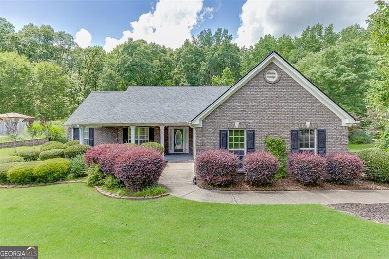 Welcome to this elegant 4-sided brick ranch, set on a tranquil and private lot of over half an acre. Featuring three bedrooms and two bathrooms, the home delivers a well-balanced layout with durable construction and minimal exterior maintenance. Enjoy abundant natural light in the bright sunroom-perfect for morning coffee, plants, or additional lounge space. The enclosed patio expands your living area, offering a comfortable space for socializing or relaxing throughout the year, with seamless access between indoors and outdoors. Inside, discover a practical layout where the primary bedroom includes an adjacent full bath and generous closet space. Two additional bedrooms share a well-appointed secondary bathroom. The living room flows into a dining area and an efficient, well-equipped kitchen. The expansive backyard provides plenty of room for gardening, recreation, or future customization-while the lush surroundings offer a peaceful and private retreat.