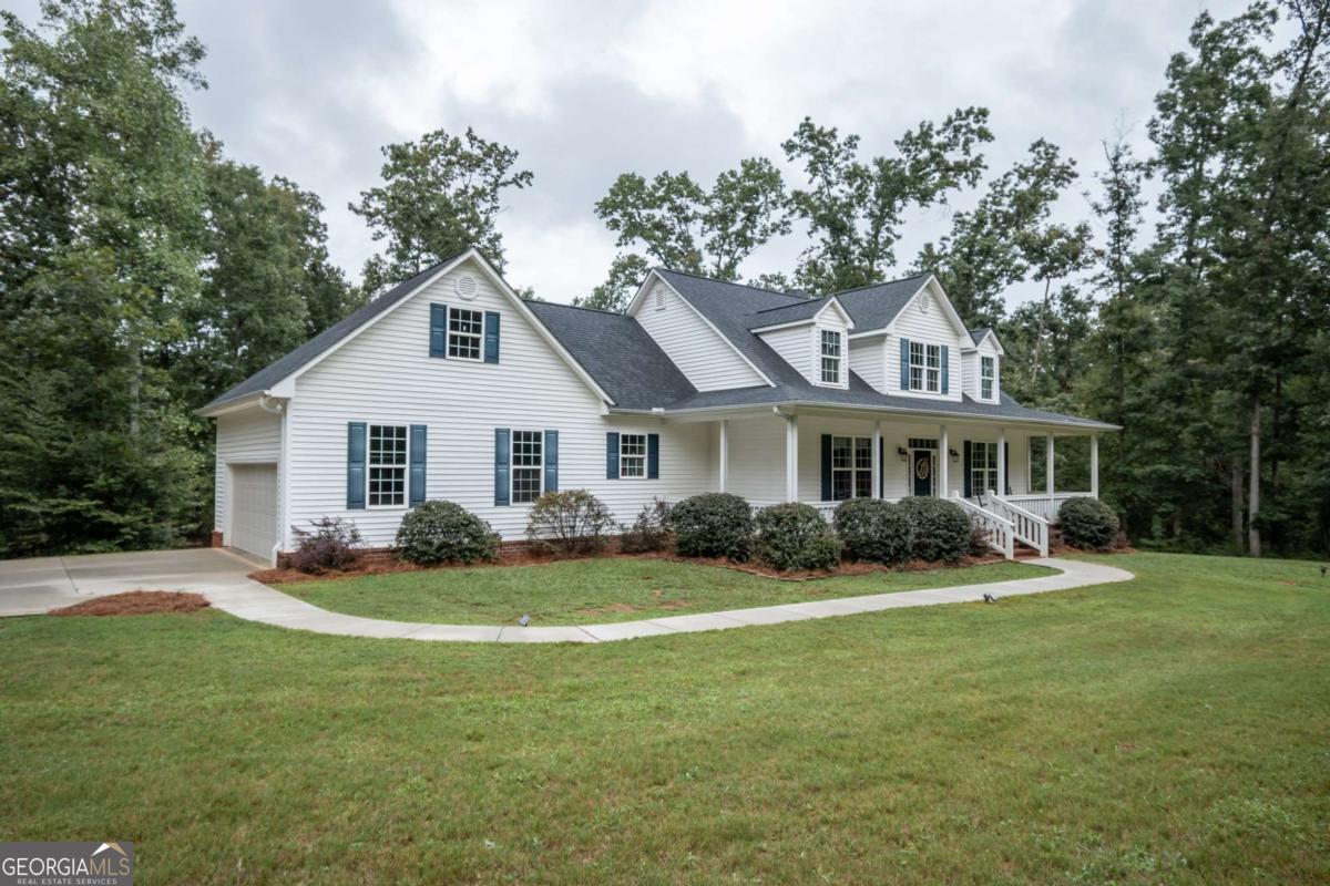 Welcome to beautiful Madison County! Tucked away in the peaceful Madison Springs subdivision, this charming home offers the perfect blend of comfort, space, and privacy on 6 serene acres. The main-level primary suite provides convenience and relaxation, while three additional bedrooms upstairs offer plenty of room for family or guests. Gather around the cozy fireplace in the living room or unwind on the screened-in back porch, where you can enjoy the sights and sounds of nature year-round. If you're seeking even more room to roam, an additional 5 acres is available for purchase separately-offering a rare opportunity to expand your private retreat.