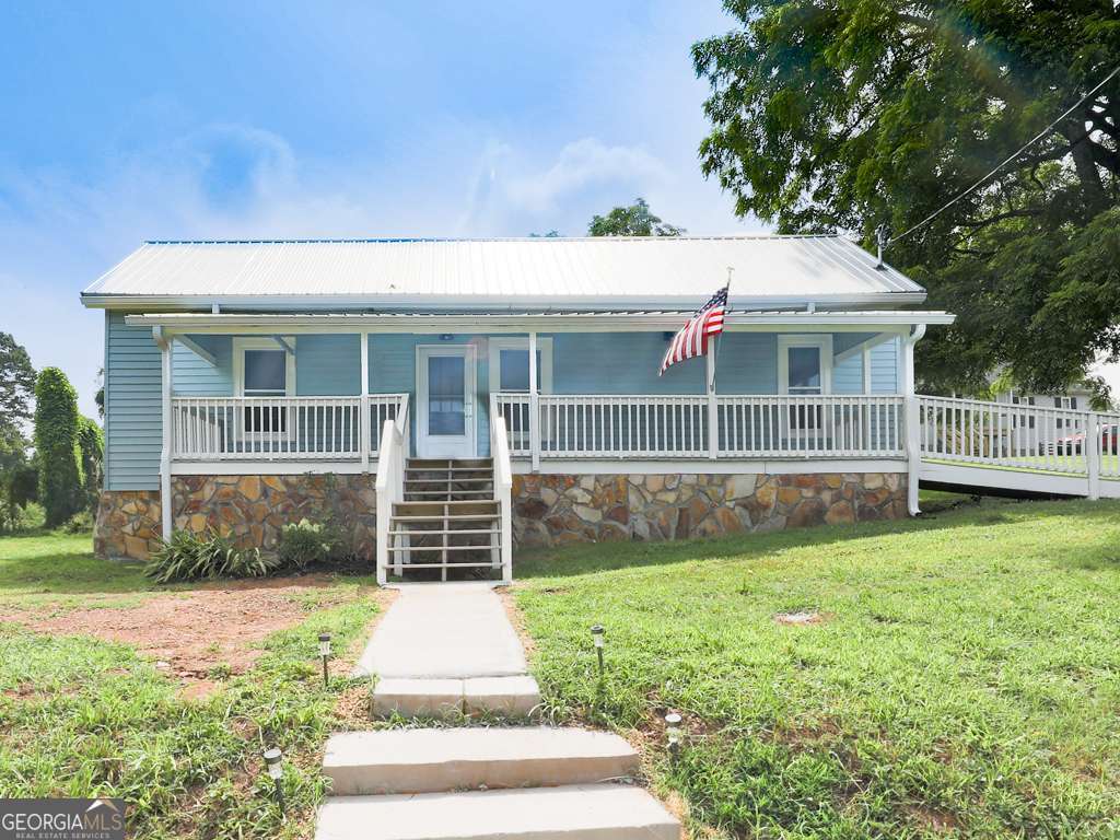 For the LOVE of OLD houses! 3/2, Country HOME with usable half acre lot situated in the heart of cozy, quaint community of Nelson, GA. Has just recently been brought up to code including all new wiring, plumbing, septic. Additionally, home has brand new metal roof, gutters, hot water heater, total electric HVAC, dual system septic. Brand new appliances, lighting, granite, bathrooms, fresh paint, LVP throughout. Gas logs fireplace. Additional highlights are the property has a new survey, Dual septic's, new insulation, new blinds and all the windows are vinyl! A perfect blend of old school and new, home has much of the original doors and trim, lovely eat in kitchen with large apron farmhouse sink. Nice huge deck on back for entertaining, big front porch overlooking neighborhood, with long range seasonal mountain views. Property includes storage building. Up-and-coming area, lots of young families out walking their children and fur babies to not one but two nearby parks. You will love this area, so convenient to both Jasper and Ball Ground, Canton and Highway 515. Great starter home, money generating rental home or retirement home.