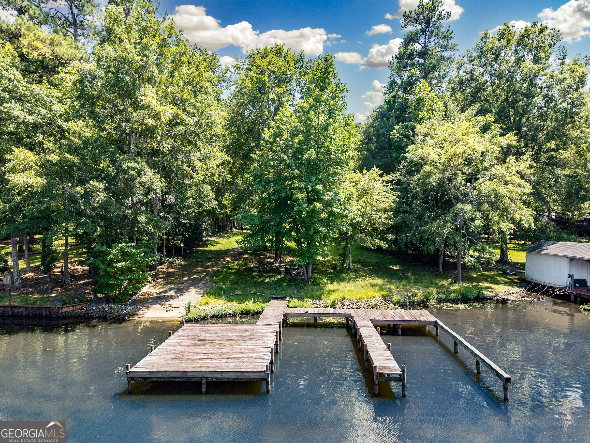 STUNNING LAKE LOT - PERFECT! Older dock in place with 2 slips. Boat ramp. Any home would work on this awesome lot! Fee Simple. Beautiful dead end street - quiet area.