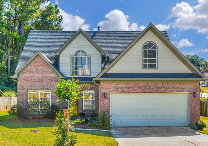 Mature crepe myrtles and evergreens welcome you to this move-in ready home with its three bedrooms, two and a half baths, and finished bonus room. The exterior features a brick front and Hardieplank siding. The two-story family room is open to the eat-in kitchen with stainless steel appliances, modern light cabinets, and generous storage space. Show off your gourmet delicacies in the adjoining dining room. Retreat to the primary bedroom on the main floor, where you can enjoy the view of your backyard. The ensuite has a soaker tub, separate shower, dual vanity, and walk-in closet. Two upstairs bedrooms and a full bathroom flank the landing that overlooks the family room and kitchen. Use the bonus room upstairs as a playroom or flex room. Relax in the privacy of your fenced backyard with its sun-drenched patio. Entertain guests under the gazebo, plant your delights in the garden space, or make the backyard your pet's paradise. Additional yard space beyond the fenced area awaits your creativity. There is no HOA. This home is just minutes away from great shopping and restaurants. Nearby points of interest include Redan Recreation Center, Redan Park, Davidson-Arabia Mountain Nature Preserve, and Stone Mountain Park. Only a 10-minute drive to Emory Hillandale Medical Center and quick access to I-20 and I-285.