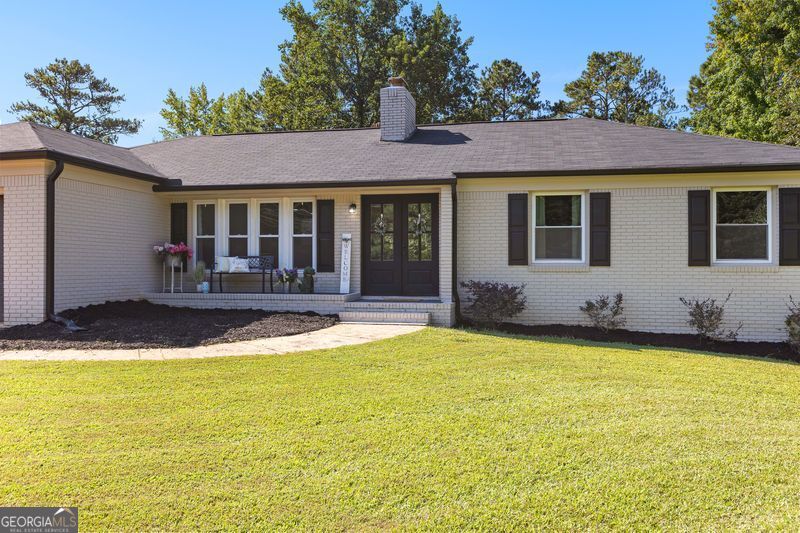 Amazing home right in the middle of everything Coweta County has to offer! 5-10 minute drive to grocery stores, restaurants, retail, schools, and activities. This 3200+/- sf home has all the space your family needs. 3 bedrooms and 2 full bathrooms on the main level along with kitchen, dining, and living room combo. Separate laundry room and office space as well. Full finished basement includes 3 more bedrooms, family room with kitchenette, full finished bathroom, flex room, and storage space. Entire home was renovated/upgraded in 2022 including new kitchen cabinets, granite/quartz countertops, stainless steel appliances, luxury vinyl plank flooring, tile shower, new bathroom vanities, new light fixtures, new interior and exterior paint, new windows, new doors, new HVAC unit, new tankless gas hot water heater, and new garage door. Did I mention the back yard...18X36 inground swimming pool with 2 levels of back decks and a large poolside covered pavilion. 2 Outdoor storage shed and a finished fire pit area! New pool pump and pool liner installed August 2025. Close proximity city living with all of the space and privacy any family woud want and need!