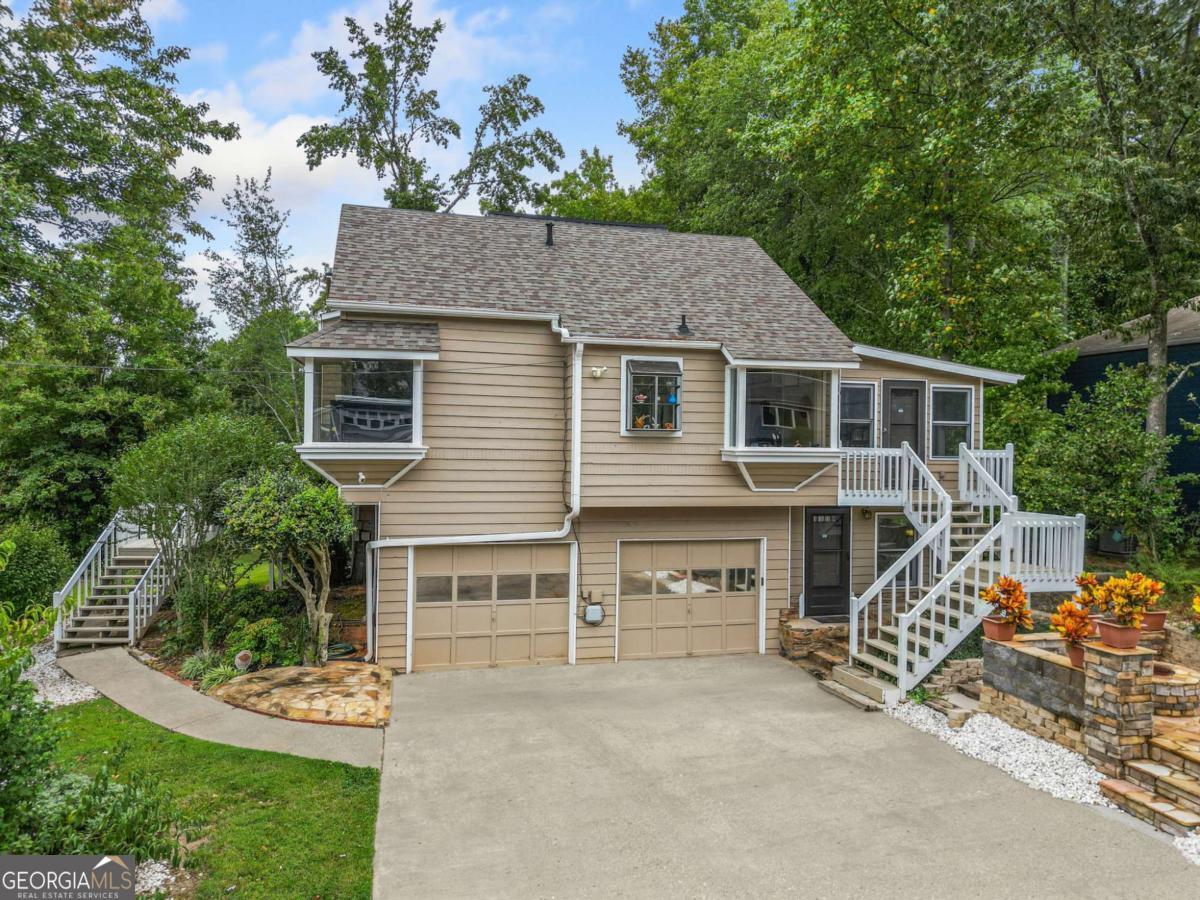 Welcome to this stunning 5-bedroom, 3-bath home, perfectly situated on a peaceful cul-de-sac in the highly sought-after East Cobb area of Marietta! Boasting an open-concept floor plan, the inviting family room features a cozy fireplace, ideal for gatherings or relaxing evenings. The large kitchen comes complete with stainless steel appliances and plenty of room to add an island, giving you the flexibility to create your dream culinary space. One of the home's highlights is the extended theatre and relaxation room across from the first floor master bedroom. The home also features a lower lever bedroom, accessed on one side by a unique spiral staircase, with its own private exit to the fountain area. Work from home or unwind in the sun-drenched sunroom, currently used as a relaxation center or home office or relaxation. There is also a private, secluded functional office off of the garage. Set on a large corner lot, this property is a gardener's and entertainer's dream, featuring a greenhouse, exotic tropical fruit trees, a serene water fountain, and beautifully landscaped grounds. Located in prestigious East Cobb, you'll enjoy access to top-rated schools, upscale shopping, and recreation just minutes away. Bonus: All furnishings and even the two automobiles are negotiable with the sale! Up to $34,950 in Down Payment Assistance available to qualified buyers through our Preferred Lender - making this an incredible opportunity! Don't miss out - schedule your private showing today!