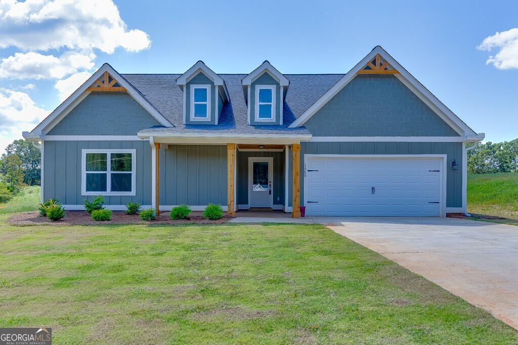 Discover unparalleled tranquility and sophisticated rural living with The Farmhouse Collection at Martin Farms - Martin, GA. This large ranch-style residence, featuring three bedrooms and two baths, is set on an expansive 1+ acre estate lot free from the constraints of any homeowners association (NO HOA!). Immerse yourself in the charm of country life with luxury amenities designed for modern comfort. The home boasts farmhouse curb appeal, waterproof LVP flooring throughout (NO CARPET), and a primary suite with a stylish oversized tiled shower for a luxurious yet contemporary feel. This well-built home also includes a covered back patio overlooking your large pasture yard, fiber cement siding, & architectural shingles. The home also boasts a well-appointed kitchen, stainless steel appliances, and white shaker cabinets. Experience the perfect blend of rural charm and refined living in this exceptional property.