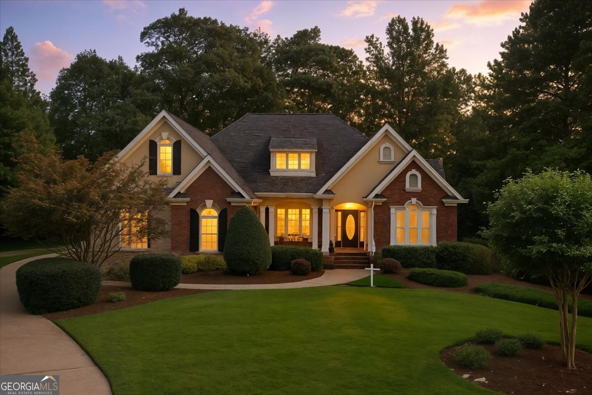 Welcome to 107 River Forest Drive - a stunning 4-bedroom, 3-bath home nestled on a beautifully landscaped 1.21-acre lot in the highly sought-after River Forest gated community. This elegant residence boasts timeless curb appeal with a brick exterior, arched windows, and immaculate grounds. Inside, you'll find spacious living areas filled with natural light, a thoughtfully designed floor plan, and high-end finishes throughout. The chef's kitchen opens into a cozy family room-perfect for entertaining. The master suite features a luxurious en-suite bath and a walk-in closet. Generously sized secondary bedrooms and well-appointed bathrooms ensure comfort for the whole family. Enjoy peaceful mornings on the front porch or relax in the serene backyard, surrounded by mature trees and lush landscaping. Located in Monroe County's top-rated school district, this home offers the perfect blend of privacy, community, and convenience. Don't miss this rare opportunity to own in one of Forsyth's premier neighborhoods. Schedule your private showing today!
