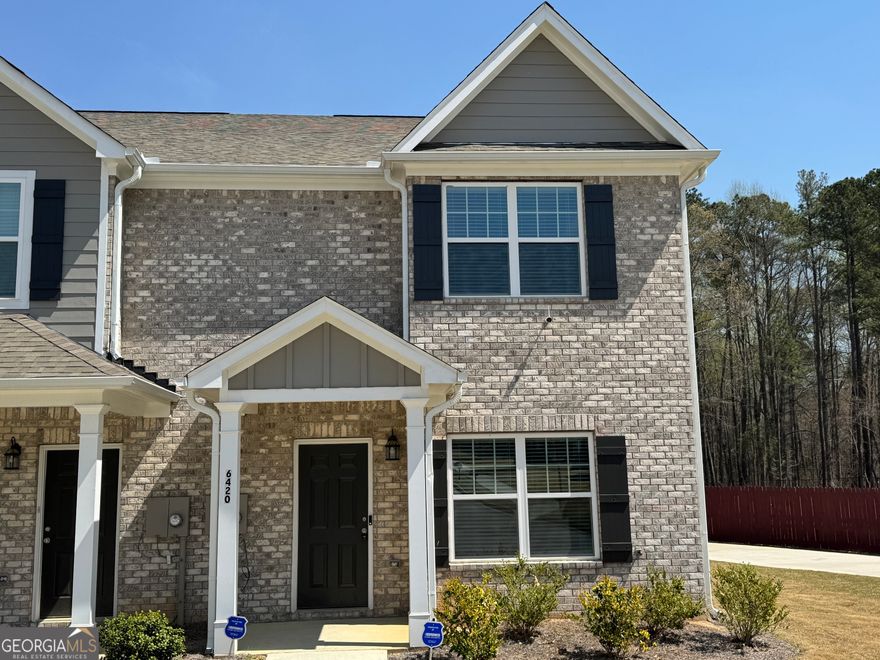 End Unit townhome with side-yard. 3 bedroom, 2 and a half bath, only a year old! Home is spacious and conveniently located south of Atlanta. The large family room features color changing electric fireplace, open to the fully equipped kitchen with modern grey shaker cabinets, granite countertops and work island, refrigerator is included! Convenient Half bath on the main floor.  Upstairs the primary suite features a tray ceiling with fan, spacious closet and ensuite bathroom with double vanities, separate shower & soaking tub. 2 additional bedrooms and full bathroom, laundry room appropriately close to all bedrooms in hall, plus storage closet. Wood plank flooring throughout. This home has large 2-car garage + driveway for additional parking. Plenty of shopping, restaurants and entertainment nearby, and it's just 15 minutes to Atlanta airport.  $5000 Incentive with preferred lender - Agents, see private remarks.