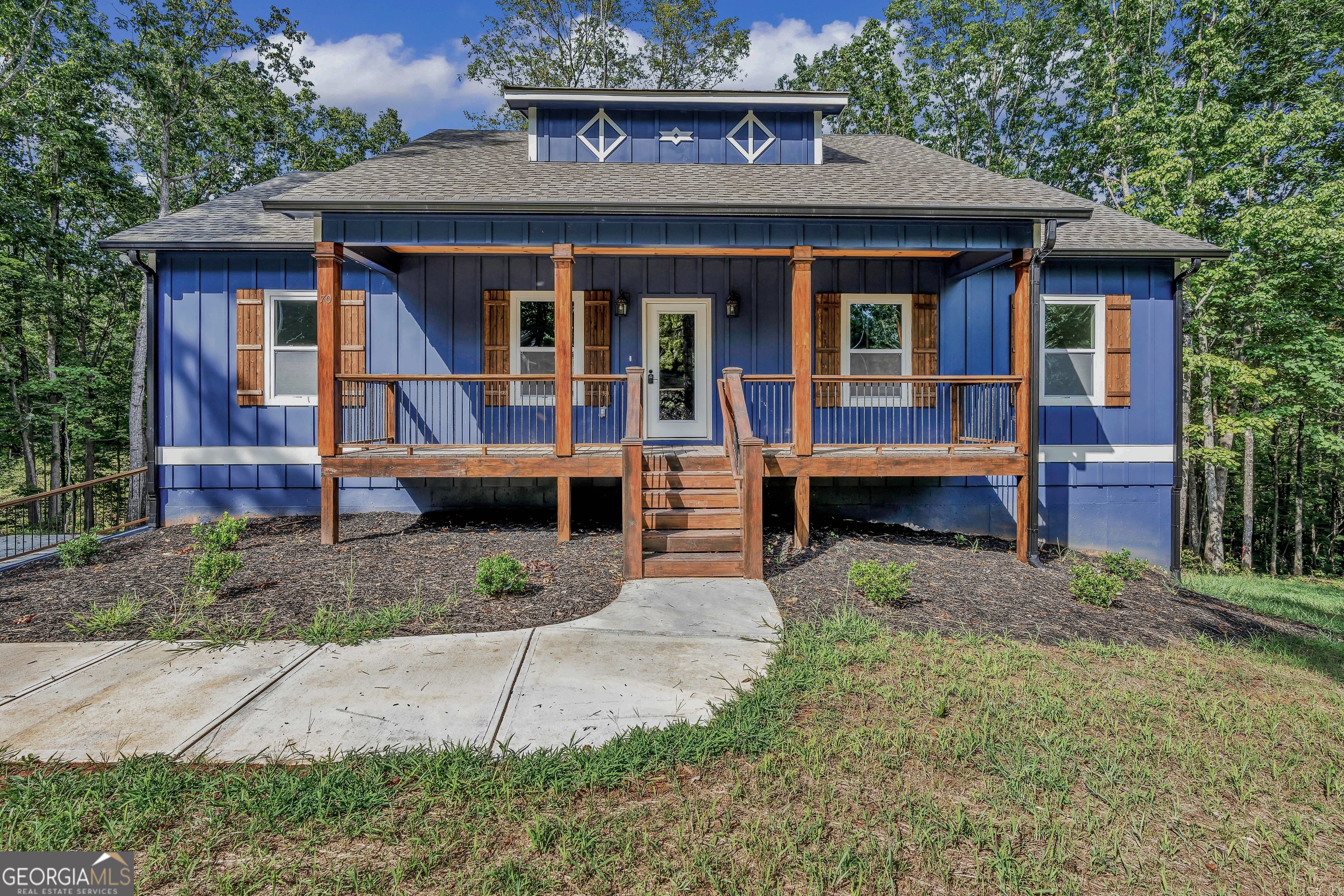Nestled on 1.99 wooded acres in the heart of the scenic North Georgia Mountains, this stunning new construction ranch offers a peaceful escape wrapped in natural beauty and modern comfort. As you step onto the welcoming covered front porch, the crisp mountain air and rustling leaves set the tone for tranquil living. Inside, the open-concept layout flows effortlessly from a warm, inviting living room into a sleek kitchen adorned with gleaming granite countertops, a sit-at island, and ample space for entertaining or family gatherings. The spacious primary bedroom is a serene retreat, featuring an ensuite bath with a luxurious oversized tiled shower and a polished granite double vanity. Downstairs, the fully finished basement offers a cozy bedroom, a bright office space with wooded views, and a media room perfect for relaxing evenings or special events!! A pull-in 2-car garage adds convenience and storage. Step out back onto the open deck to soak in the peaceful, tree-lined surroundings, or enjoy your morning coffee on the front porch as the sun rises over the mountains. Tucked into a quiet, safe neighborhood just over 10 miles from Ellijay's charming town square and a short drive to restaurants and grocery stores, this property is the ideal blend of seclusion and accessibility. Don't miss your chance to own this breathtaking mountain haven-schedule your showing today and experience mountain living at its finest!!