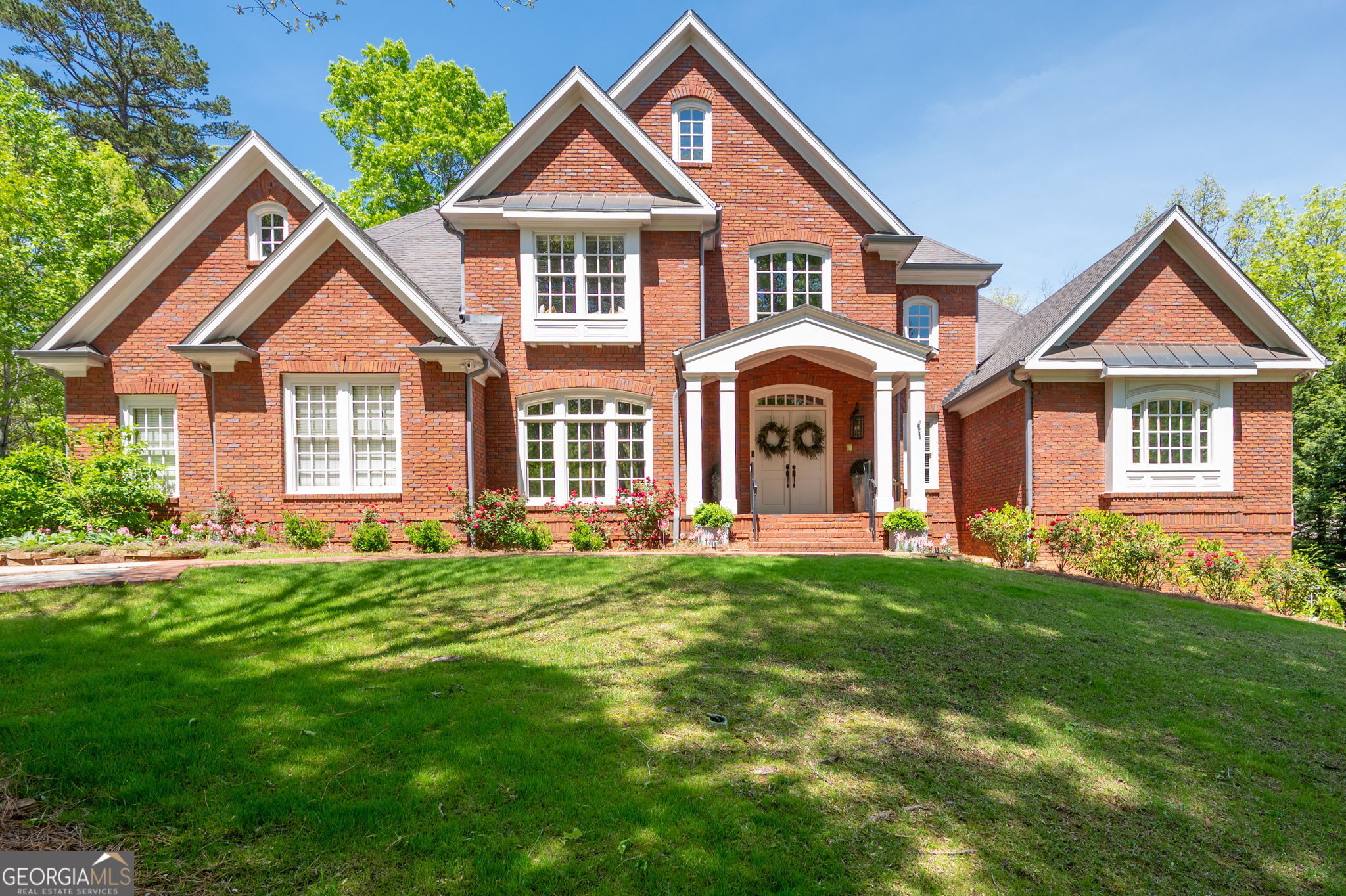 Your dream home awaits you! Luxurious 4 sided brick custom home built by Elliott Homes in sought after beautiful community of Oak Grove. Home is situated on over an acre private, cul-de-sac lot with exquisite landscaping to include several gorgeous Japanese Maples. Step into the grand 2-story foyer with lots of natural light and sets the tone for the rest of the home combining luxury with a warm welcoming ambiance. The Dining Room is perfect for gathering with family and friends for special dinners. Walk into the beautiful Great Room with cathedral ceilings, custom built-ins, fireplace and opens onto large deck overlooking park-like backyard that would be perfect for a pool! The Kitchen is a chef's dream designed for both functionality and elegance to include stainless appliances, granite counters, double ovens, gas cooktop and separate breakfast area, open to beautiful 2-story Keeping Room with stack stone fireplace, perfect for your morning coffee. Luxurious Primary Suite is on main level, a serene retreat designed for comfort and relaxation. This spacious bedroom features large private sitting area with built-in cabinets-perfect place to unwind with a book or glass of wine. Access to back deck from sitting room. Oversized Spa-like Bath features trey ceiling, separate shower and tub with his/her vanities and closets. The upstairs includes 3 large en-suite Bedrooms each offering comfort and privacy. There is also a Loft-perfect for a study, sitting area or playroom. There are two hidden rooms that the kids will be sure to love. The Terrace Level is perfect for an In-law suite featuring a spacious Living Room, Game Room, Spectacular Theater, and wet bar that can be used as a mini Kitchen, plus a Full Bath and Bedroom! Fabulous location convenient to Kennesaw National Park with miles of hiking trails, Marietta Country Club, Mount Paran Christian School, Kennestone Hospital, The Marietta Square with great restaurants, shopping, and more. Don't miss the opportunity to see this beautiful home!