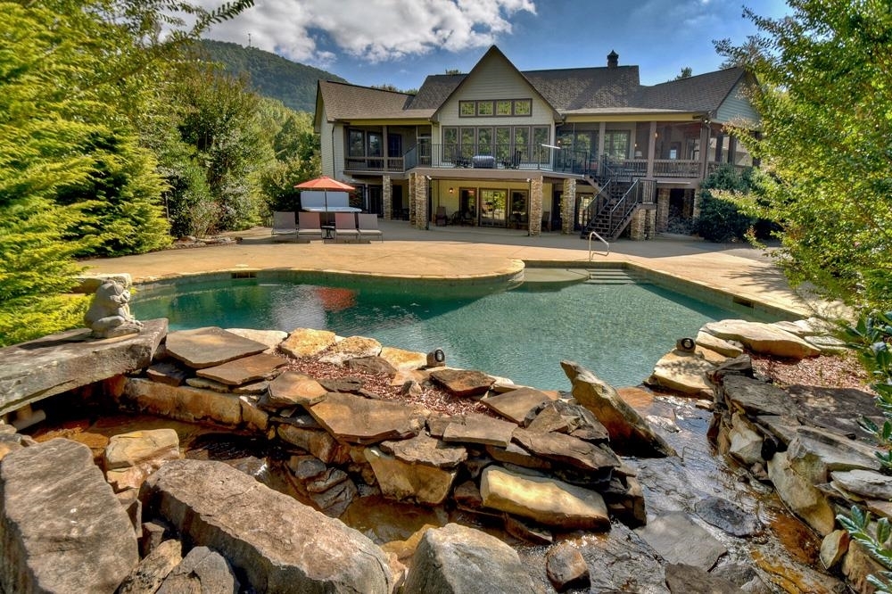 INCREDIBLE MOUNTAIN ESTATE IN THE HEART OF ASKA ADVENTURE AREA....AND ONLY 5 MILES TO DOWNTOWN BLUE RIDGE! This completely private estate sits on 7.69 acres offering 5 bedrooms, 4 full-baths/2 half-baths, main level owners suite w/custom tiled bath/shower, sitting area perfect for office/workout area and private screened in deck overlooking the pool, gourmet kitchen w/upgraded appliances and custom cabinetry, living area w/floor-to-ceiling stacked stone fireplace, main level open deck and screened in porch, full-finished basement w/second kitchen & bar, bonus room easily converted to theatre room, recreation room w/fireplace, access to expansive patio with ground pool & water fall, new hottub, 2-car oversized garage w/bonus room above, fenced in area, detached storage shed, lean-to shed on bottom part of property, gated entrance and additional prepped building site. Exceptional Features!