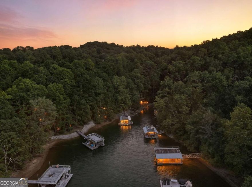 Point Twenty Two: a private, wooded canvas for your legacy home.        Welcome to Point Twenty Two-a rare slice of Lake Lanier where serenity meets possibility. Tucked among towering hardwoods, this wooded 0.77-acre lot invites you to imagine mornings wrapped in birdsong, coffee steaming on your porch while sunlight filters through the trees. The home you design here will perch above the water like a modern treehouse, with a walk-out terrace level that brings the outdoors in.        Stroll down the slope to the lake's edge, where you can create your own gathering spot-a firepit for crisp autumn evenings, Adirondack chairs for lingering sunsets, and space to watch the reflections dance on the water. Though this parcel does not carry a dock permit, the intimate frontage makes the lake feel like an extension of your backyard.        Surrounded by million-dollar homes in an ultra-private enclave, this property delivers both prestige and peace. It's the perfect canvas for a tranquil retirement retreat, a legacy home where family and friends gather, or a multi-generational sanctuary that blends privacy with connection. Here, luxury isn't just a style-it's a lifestyle.