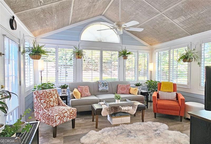 Welcome Home to The Vineyards - A Sought-After Community in Kennesaw! Discover easy living in this stunning, beautifully maintained patio home offering a private setting and resort-style amenities, all just minutes from premier restaurants, shopping, and everyday conveniences. Step inside to a bright and open floor plan featuring a vaulted great room with a gorgeous, custom-updated fireplace - perfect for cozy nights in or entertaining guests. The open-concept dining area flows seamlessly into the well-appointed kitchen, complete with white cabinetry, quartz countertops, custom tile backsplash, under and over-cabinet lighting, and a nice pantry. The spacious owner's suite is a true retreat, featuring a large palladium window, double sink vanities, a walk-in shower, linen closet, and an oversized walk-in closet. Two additional bedrooms offer plenty of space for guests, office, or hobbies, and share a large full bathroom with a tub/shower combo. Appreciate your morning coffee or unwind in the sun-drenched sunroom, the perfect spot for relaxation year-round. A laundry room with built-in cabinetry provides extra storage, and the two-car garage includes even more storage plus pull-down attic access. Additional highlights include: New flooring and fresh paint throughout, Plantation shutters, meticulously maintained interior and exterior. Take advantage of the community's fantastic amenities: a clubhouse, fitness center, swimming pool, and serene pond views with water features - all nestled in a peaceful, friendly neighborhood. Don't miss your opportunity to own this exceptional home in one of Kennesaw's most desirable communities!
