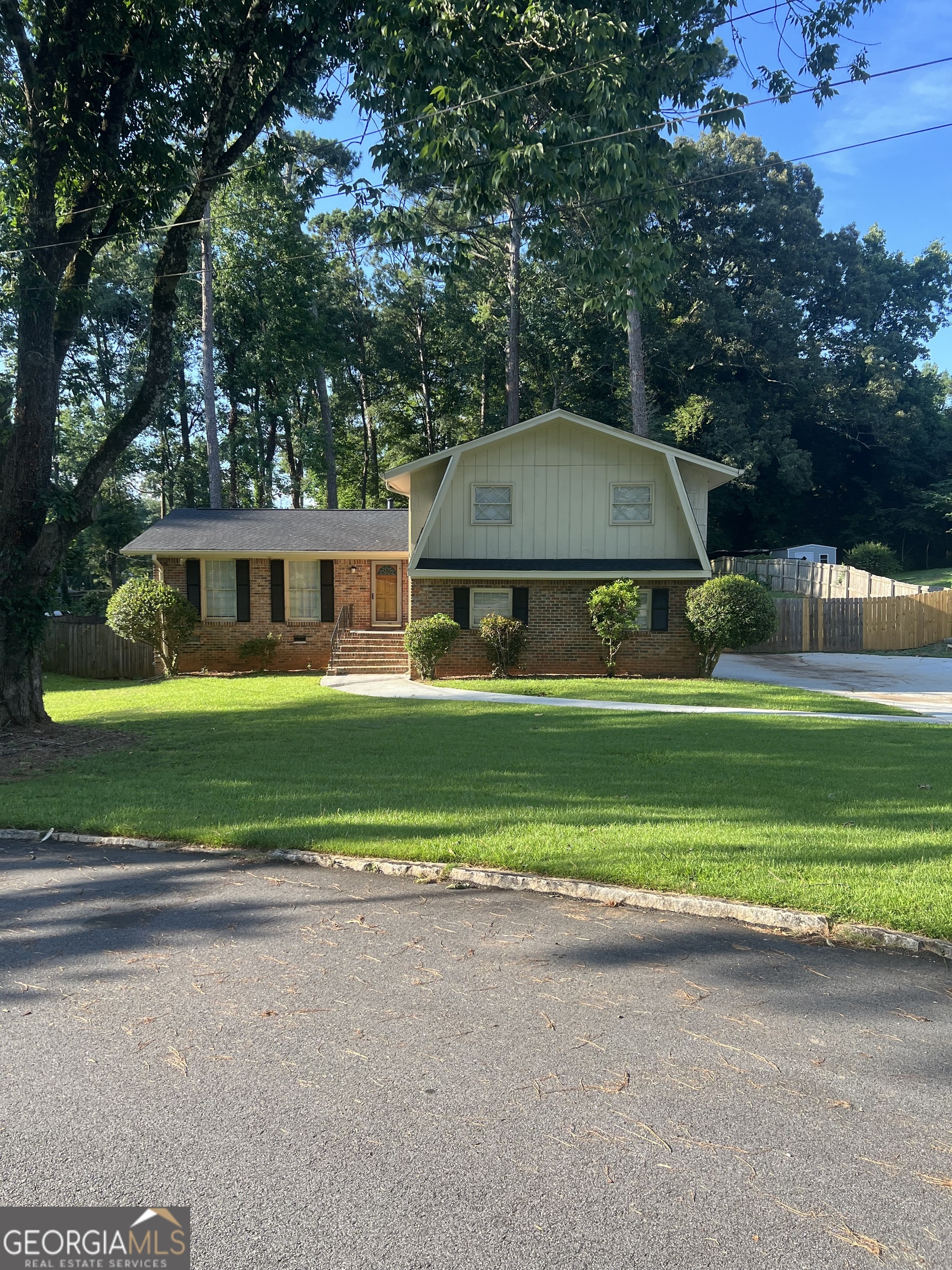 Welcome to 4910 Thompson Mill Rd in Stonecrest, GA! This beautifully updated brick and wood siding home, built in 1968, sits on a spacious half-acre lot in the sought-after Stonecrest area. Step inside to find gleaming hardwood floors throughout the main living areas, freshly painted interiors, and modern finishes that create a warm and inviting atmosphere. The kitchen is thoughtfully upgraded with stone countertops and updated cabinetry, while the bathrooms feature stylish new vanities. Recent improvements, including a gently used HVAC system and roof, provide added comfort and peace of mind. A finished den offers flexible living space-perfect for a recreation room, home office, or guest retreat. Outside, the generous yard invites gardening, play, or entertaining. Conveniently located near shopping, parks, and expressway access, this well-maintained home blends comfort, convenience, and long-term value.