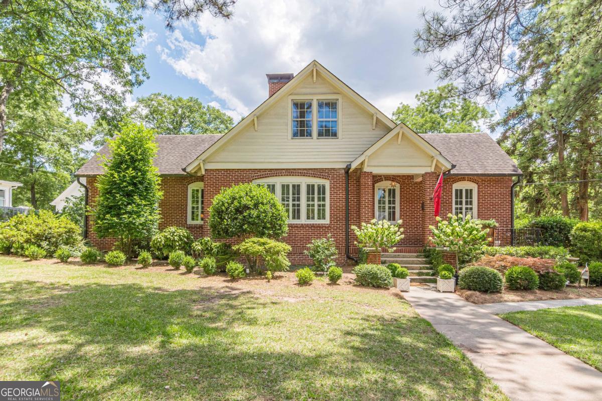 This stunning all-brick home blends timeless charm with modern updates in the heart of Historic College Park. The beautifully renovated kitchen features high-end finishes, a spacious island with seating, and an eat-in area-perfect for gatherings. A separate formal dining room offers additional space for entertaining, seamlessly connecting to a cozy living room and an inviting all-season sunroom, ideal for hosting or relaxing year-round. The main-level primary suite provides convenience and comfort, while a second bedroom with an en-suite bath makes a perfect guest room or home office. Upstairs, a separate living area serves as an ideal teen retreat, entertainment zone, or remote work space-anchored by three additional bedrooms and a full bath. Gleaming hardwood floors flow throughout the home, complemented by abundant storage options, including easy-access attic space and a spacious basement. Situated within walking distance to Woodward Academy and minutes from major destinations like Delta HQ, Porsche, Hartsfield-Jackson Atlanta Airport, and downtown Atlanta. Enjoy proximity to public transportation, restaurants, and major highways-all from a vibrant and historic neighborhood.